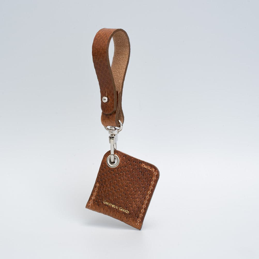 A stylish Leather AirTag bag charm made from premium Italian leather, showcasing its rich texture and customizable features.