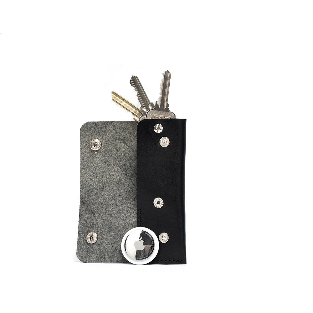 Leather AirTag Key Case 3.0 in premium Italian leather with golden hardware, holding an AirTag and keys.