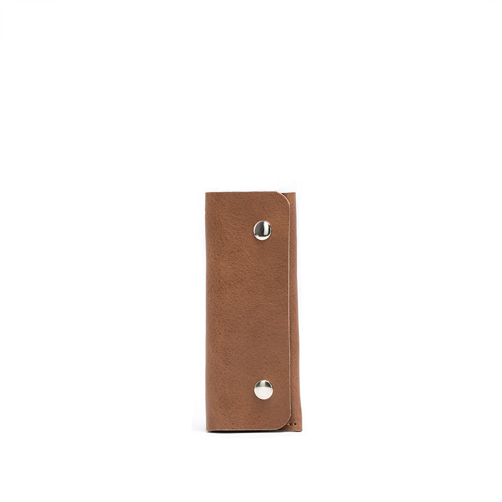 Leather AirTag Key Case 3.0 in premium Italian leather with golden hardware, holding an AirTag and keys.