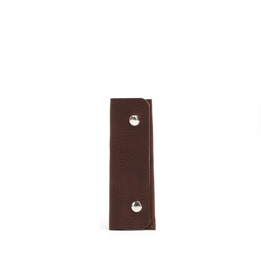 Leather AirTag Key Case 3.0 in premium Italian leather with golden hardware, holding an AirTag and keys.