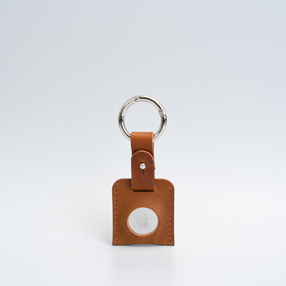 A stylish Leather AirTag Keychain made from premium Italian leather, featuring a durable circle carabiner and customizable design options.