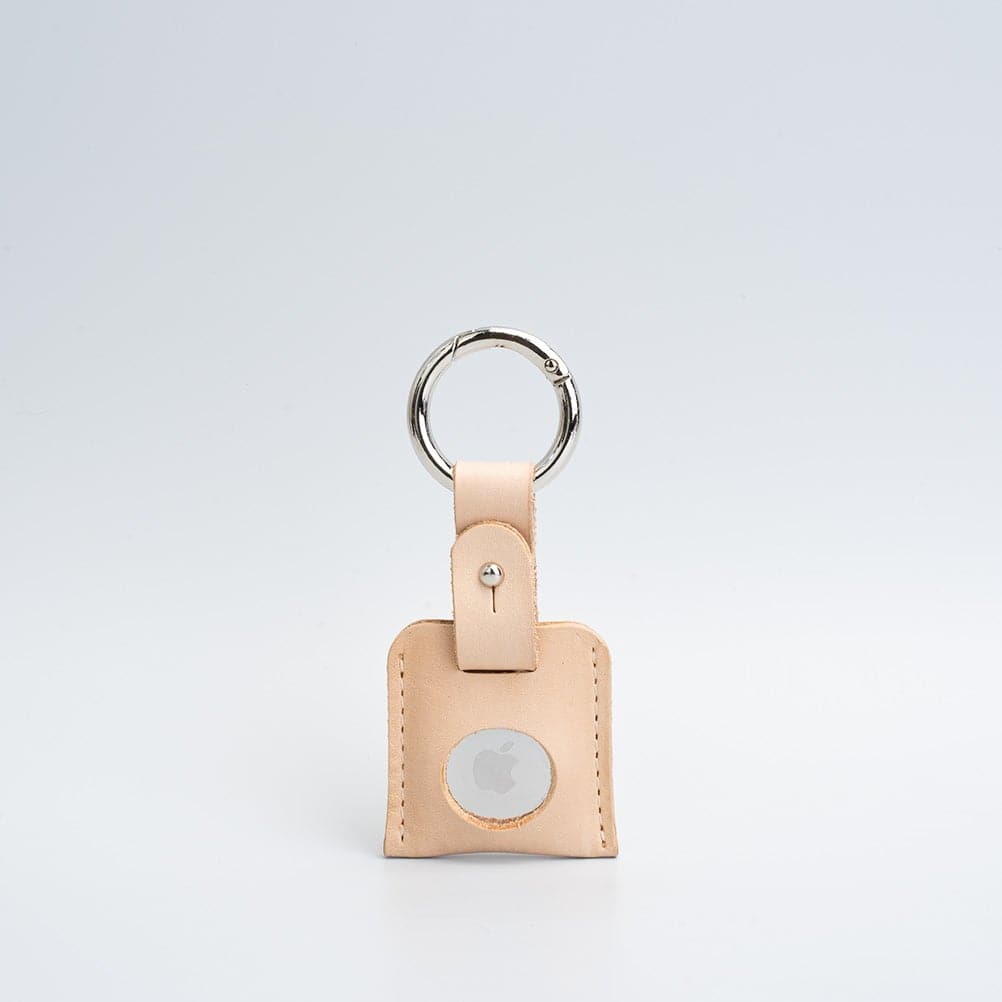 A stylish Leather AirTag Keychain made from premium Italian leather, featuring a durable circle carabiner and customizable design options.