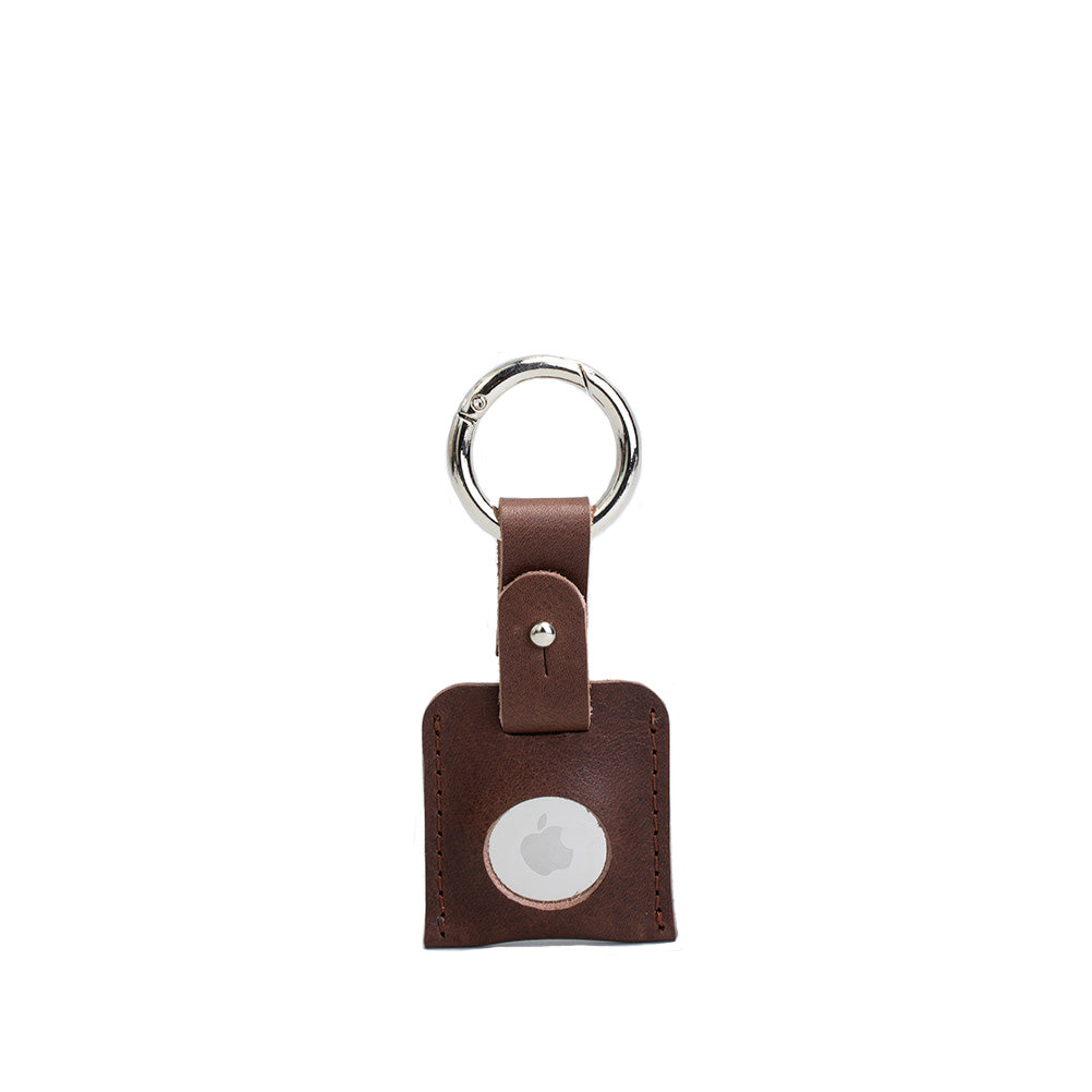 A stylish Leather AirTag Keychain made from premium Italian leather, featuring a durable circle carabiner and customizable design options.