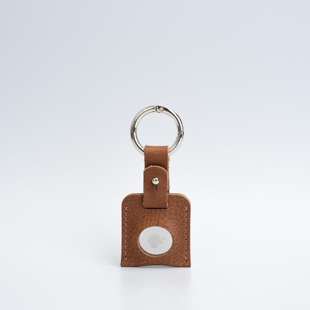 A stylish Leather AirTag Keychain made from premium Italian leather, featuring a durable circle carabiner and customizable design options.