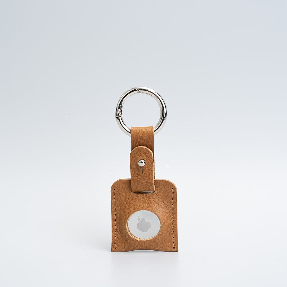 A stylish Leather AirTag Keychain made from premium Italian leather, featuring a durable circle carabiner and customizable design options.