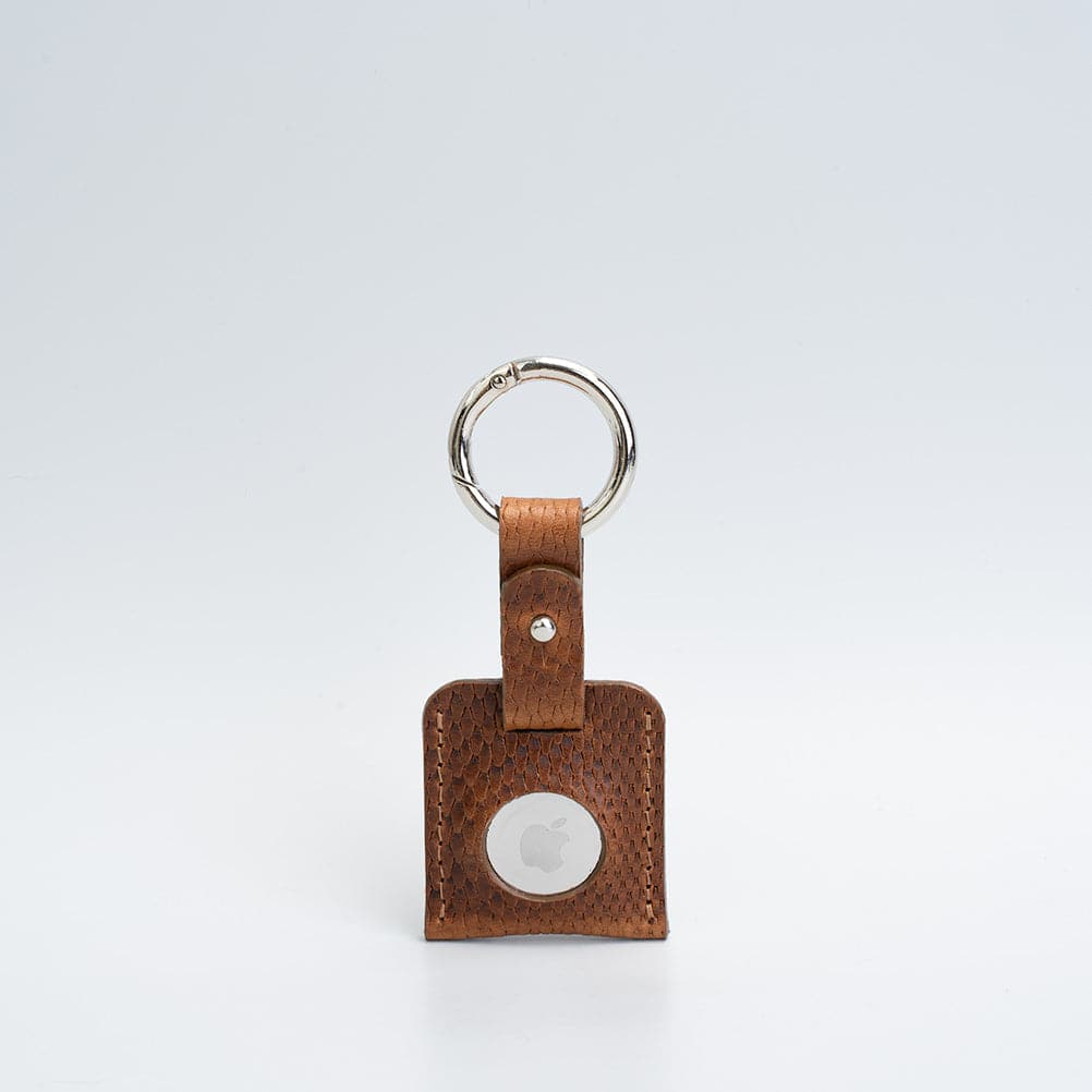 A stylish Leather AirTag Keychain made from premium Italian leather, featuring a durable circle carabiner and customizable design options.