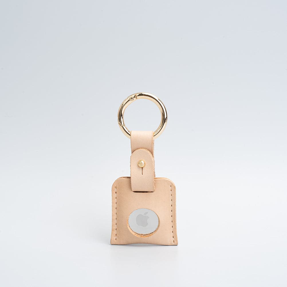 A stylish Leather AirTag Keychain made from premium Italian leather, featuring a durable circle carabiner and customizable design options.