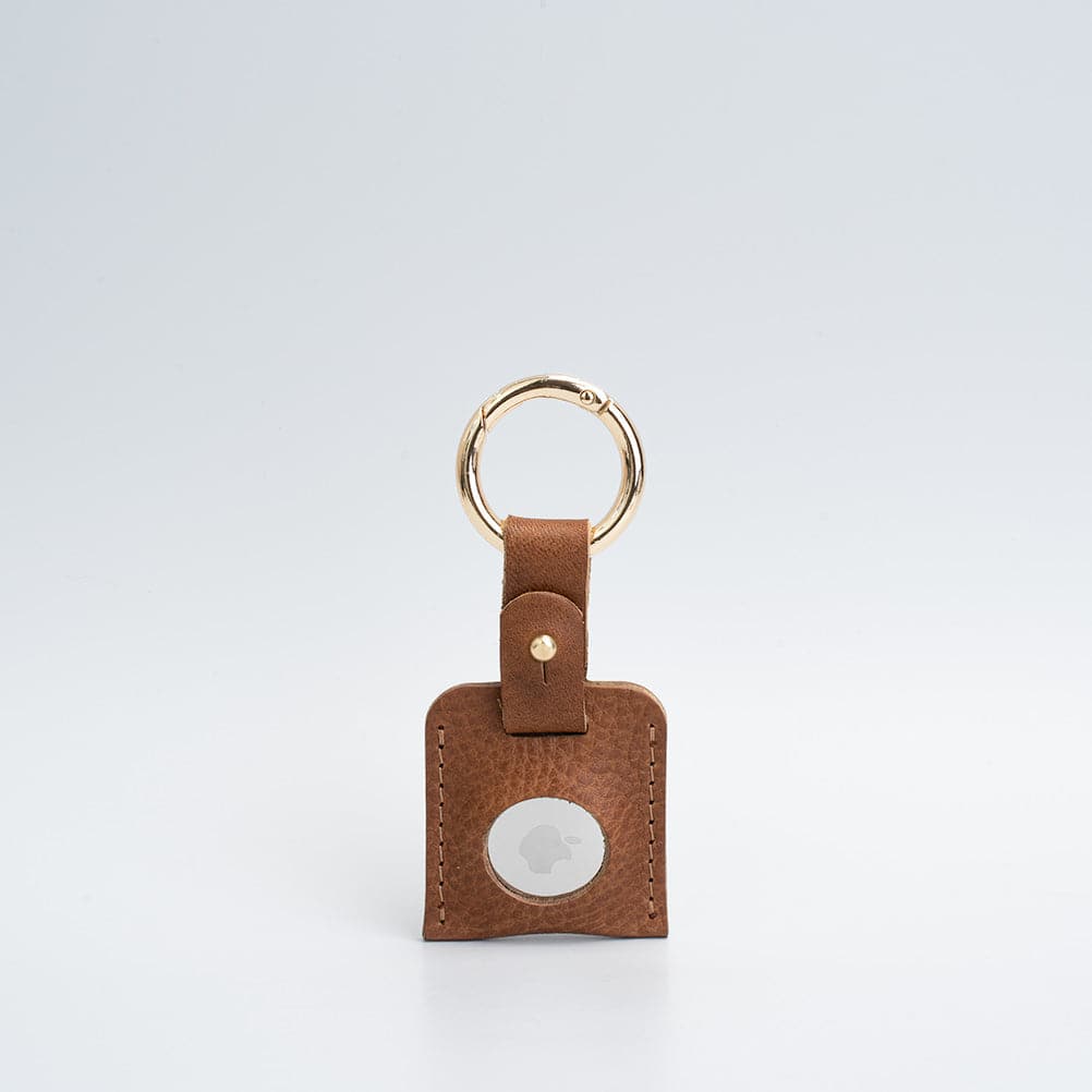 A stylish Leather AirTag Keychain made from premium Italian leather, featuring a durable circle carabiner and customizable design options.