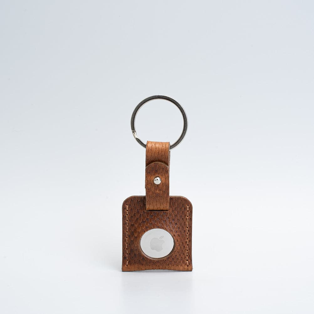 A stylish Leather AirTag Keyring made from premium Italian leather, showcasing its craftsmanship and customizable features.