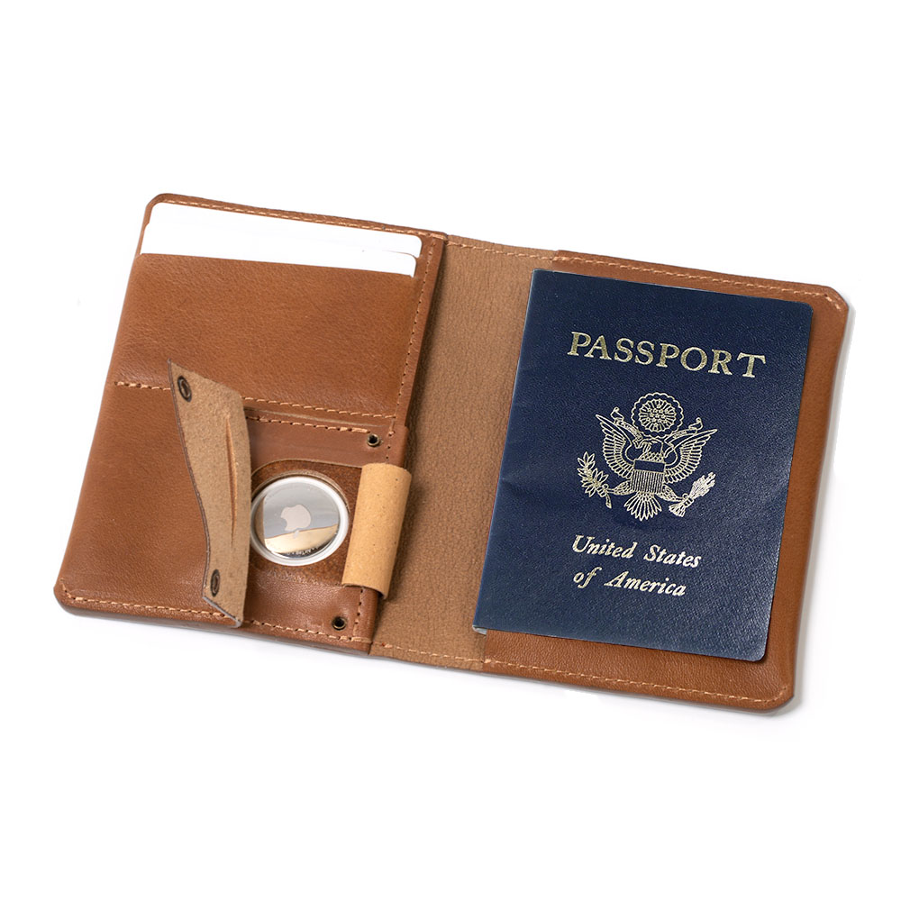 Leather AirTag Passport Holder in rich Italian leather, featuring a hidden AirTag pocket and snap button closure, ideal for secure travel.