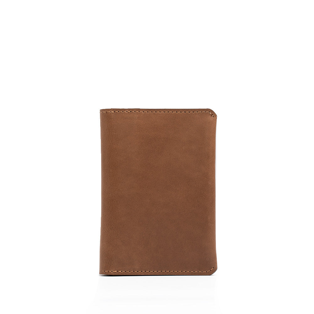 Leather AirTag Passport Holder in rich Italian leather, featuring a hidden AirTag pocket and snap button closure, ideal for secure travel.