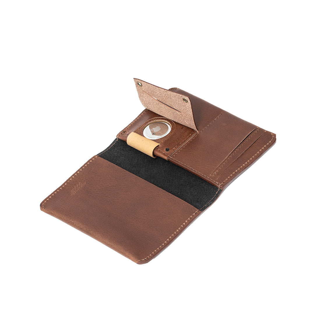 Leather AirTag Passport Holder in rich Italian leather, featuring a hidden AirTag pocket and snap button closure, ideal for secure travel.