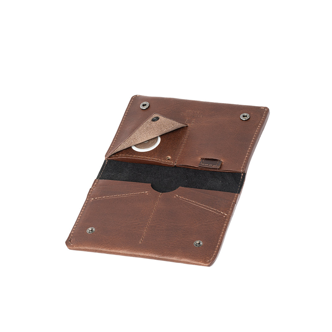 Leather AirTag Travel Wallet in Italian vegetable tanned leather, featuring a hidden AirTag pocket and snap button closure.