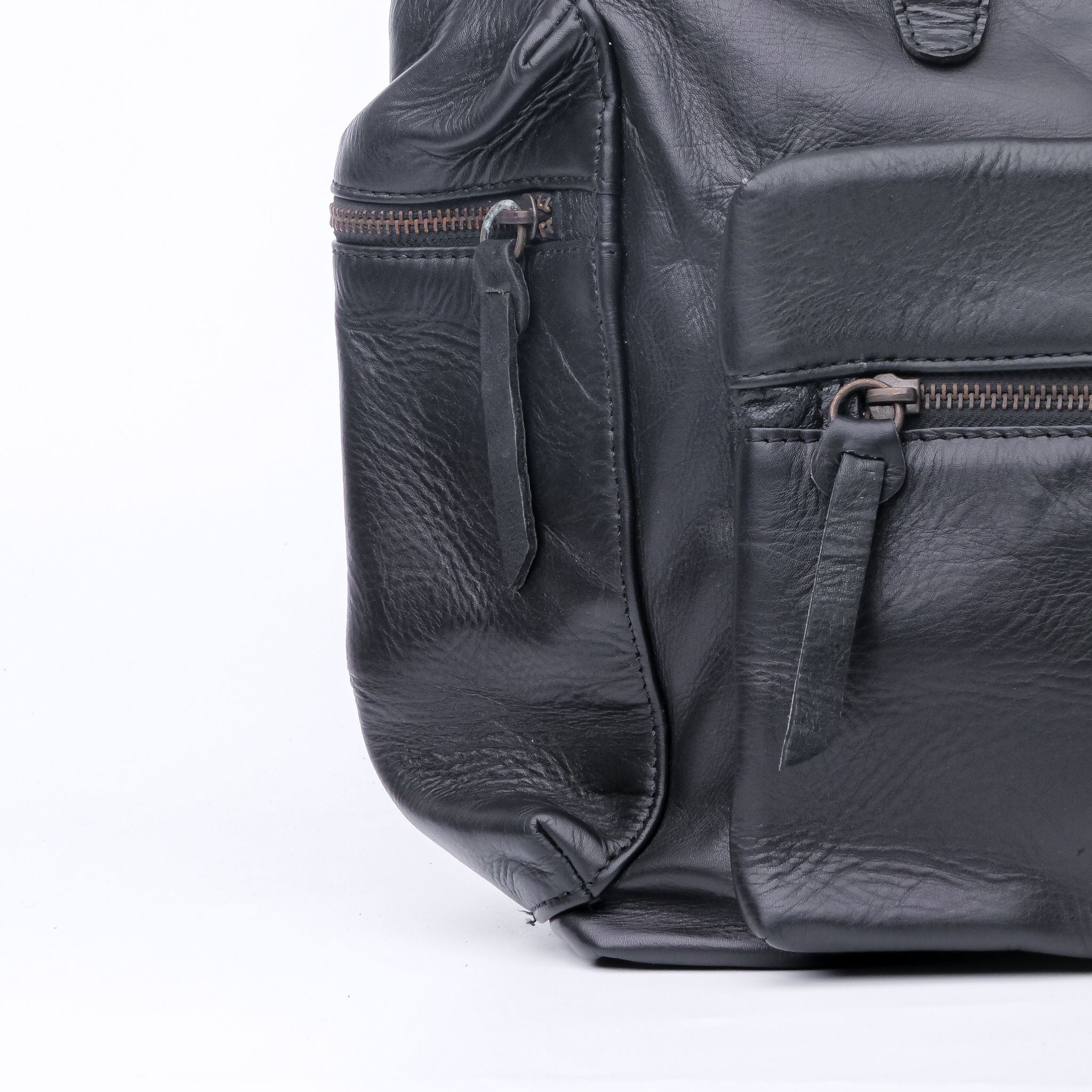 Granite Black Leather Backpack with double adjustable straps and golden hardware, showcasing its elegant design and spacious compartments.