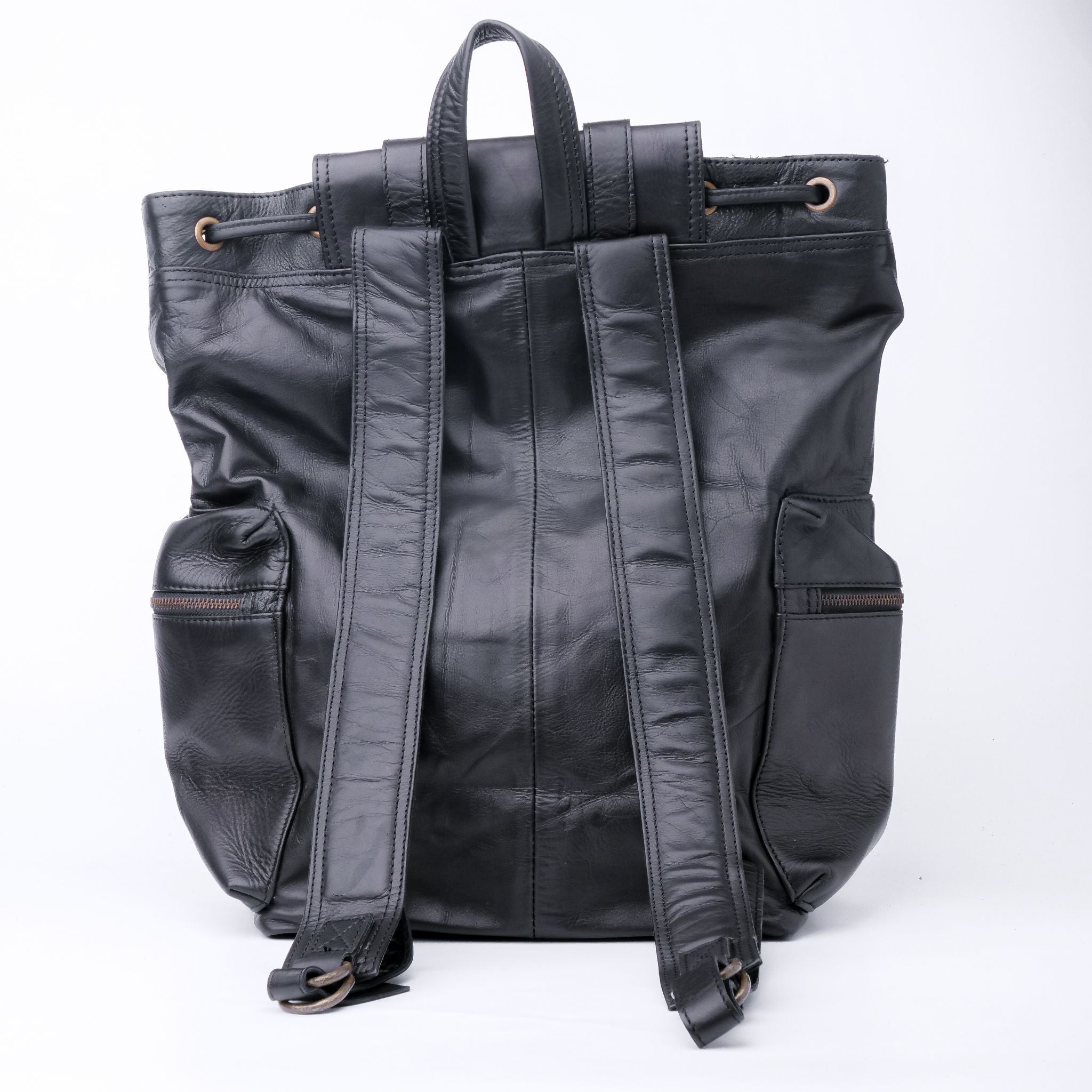 Granite Black Leather Backpack with double adjustable straps and golden hardware, showcasing its elegant design and spacious compartments.