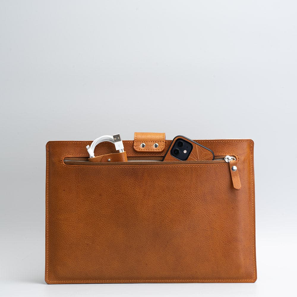 A premium leather bag for MacBook featuring a zipper pocket, crafted from full-grain leather with a wool felt lining.