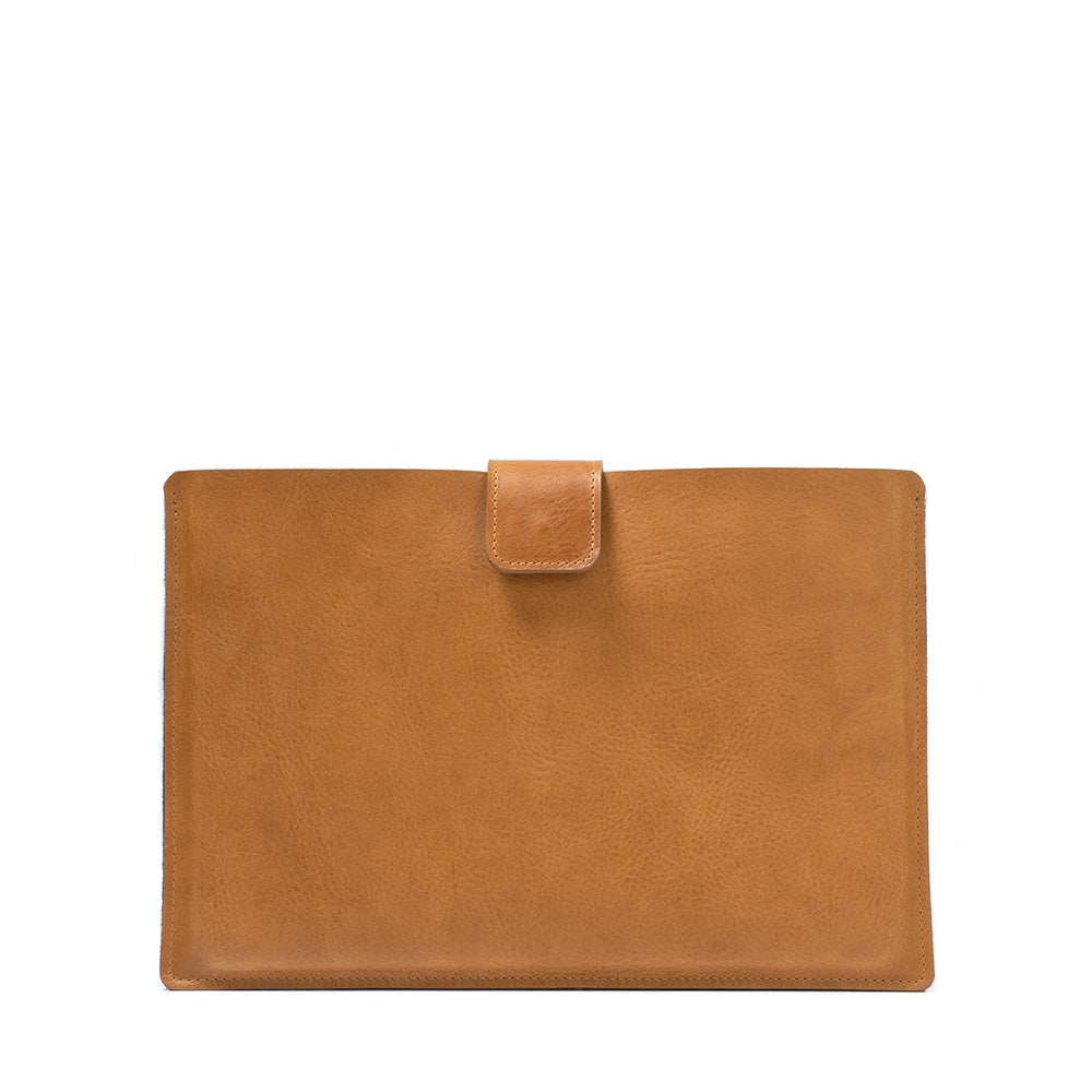 A premium leather bag for MacBook featuring a zipper pocket, crafted from full-grain leather with a wool felt lining.