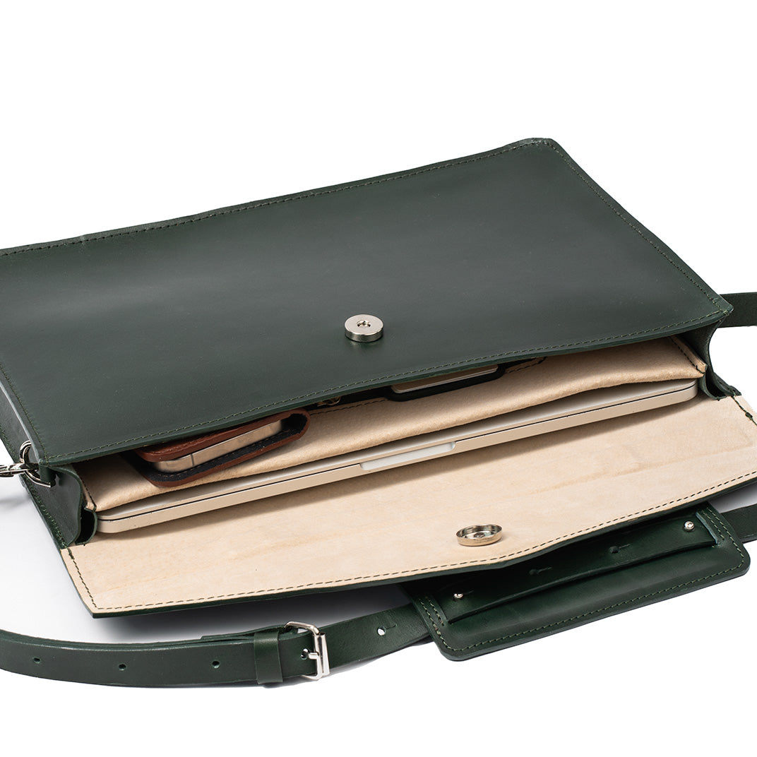 Mahogany leather briefcase featuring a sleek design, padded laptop compartment, and adjustable strap, ideal for professionals.