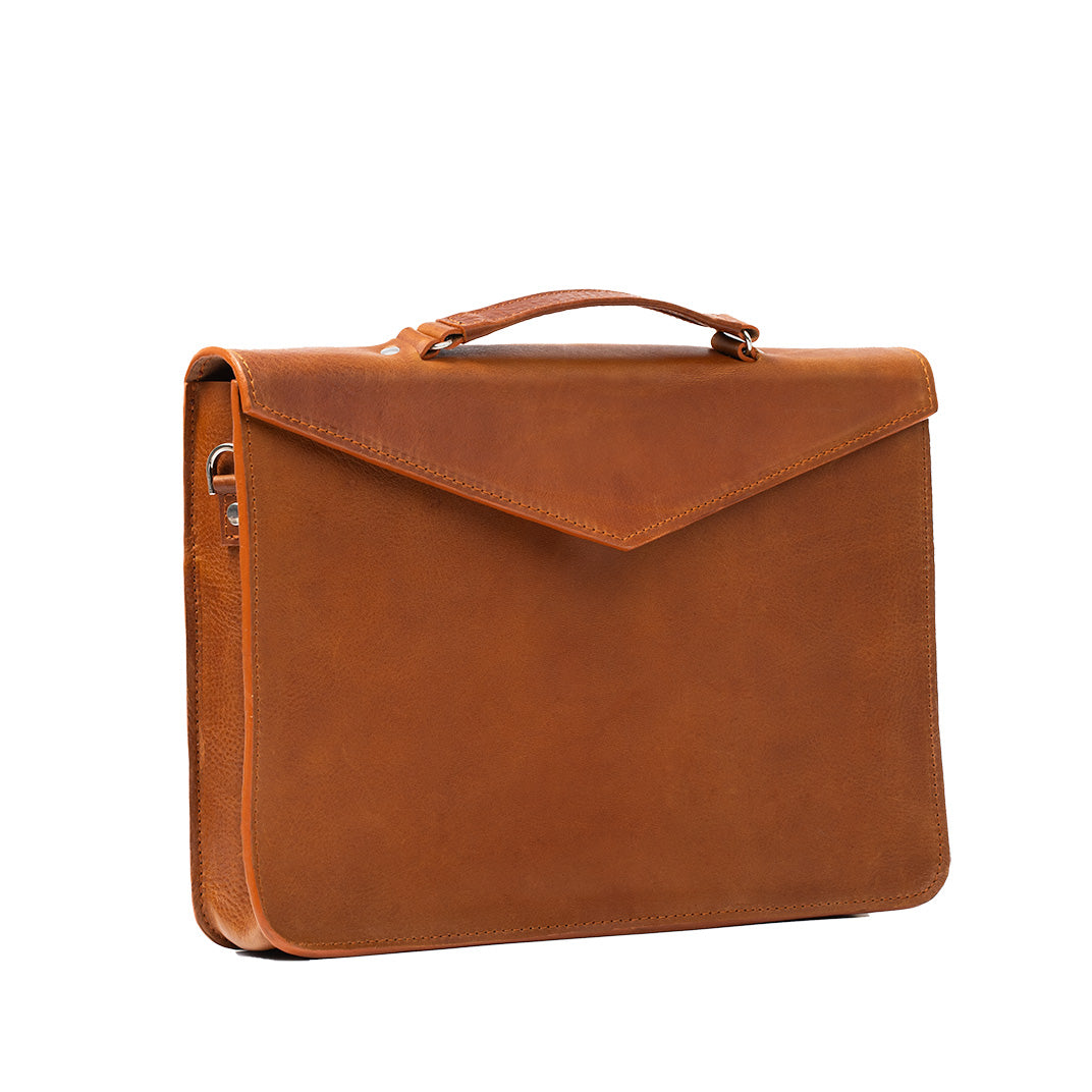 Tan leather briefcase featuring a padded laptop compartment, zippered pocket, and adjustable strap, perfect for professionals.