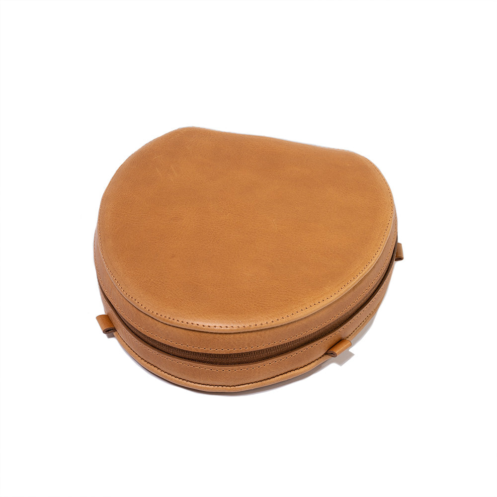 Brown leather case for AirPods Max, crafted from full-grain Italian leather with a soft lining and adjustable strap loops.