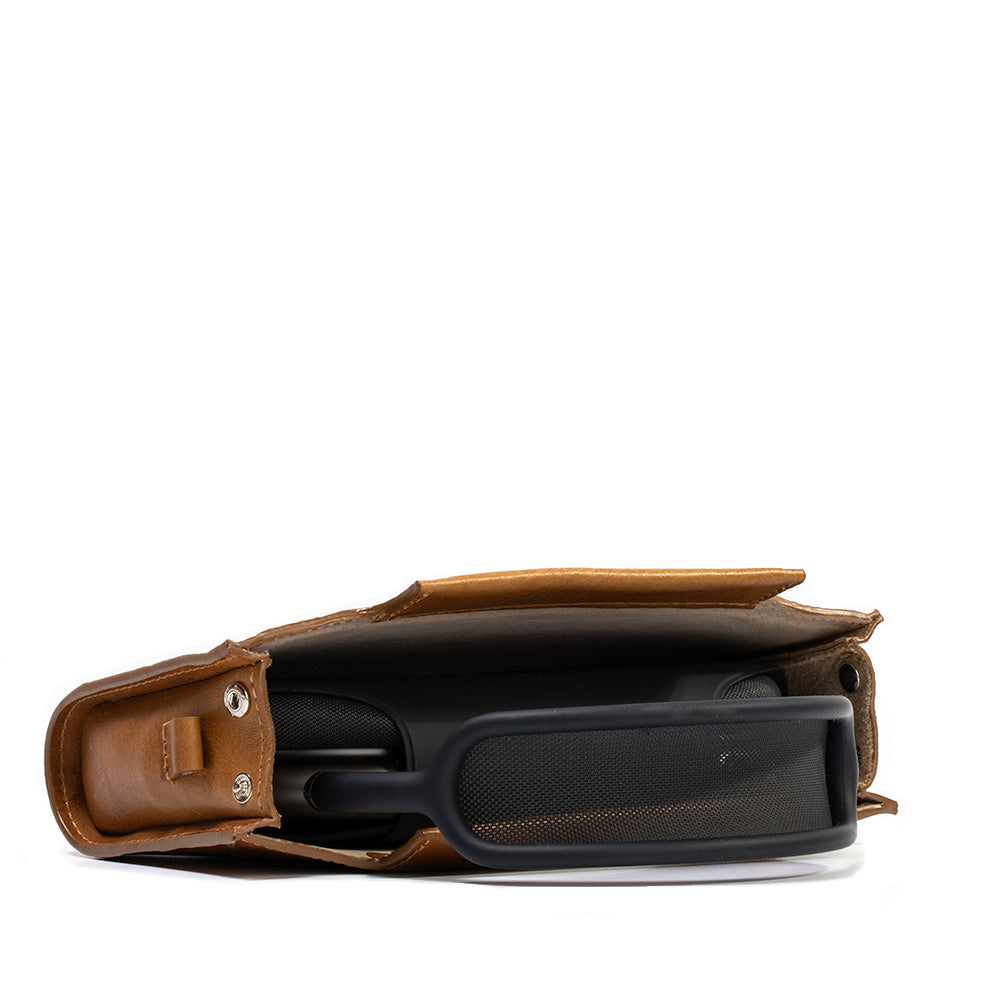 Tan leather case designed for AirPods Max, featuring adjustable strap and magnetic closures, showcasing premium Italian craftsmanship.