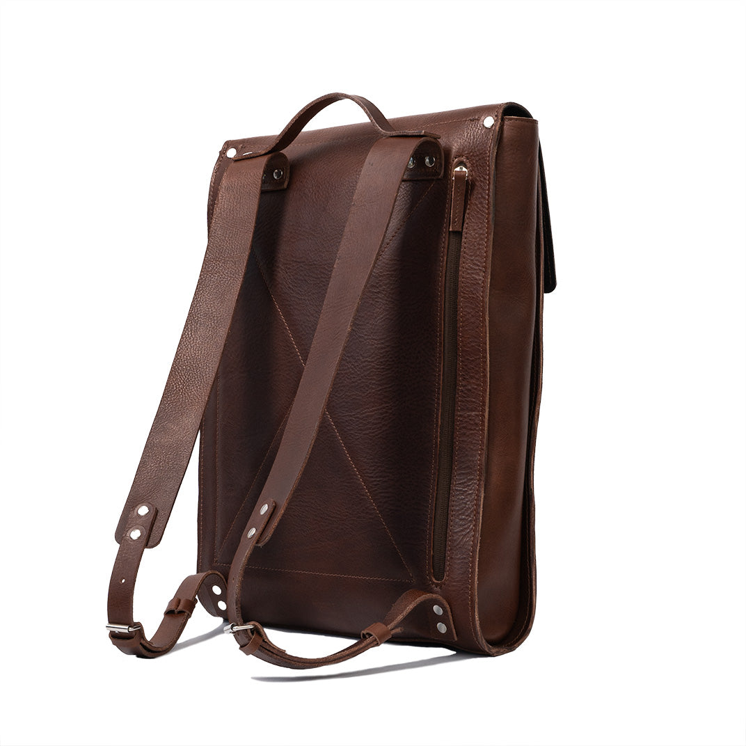 Leather laptop backpack in mahogany color, showcasing its sleek design and premium materials.