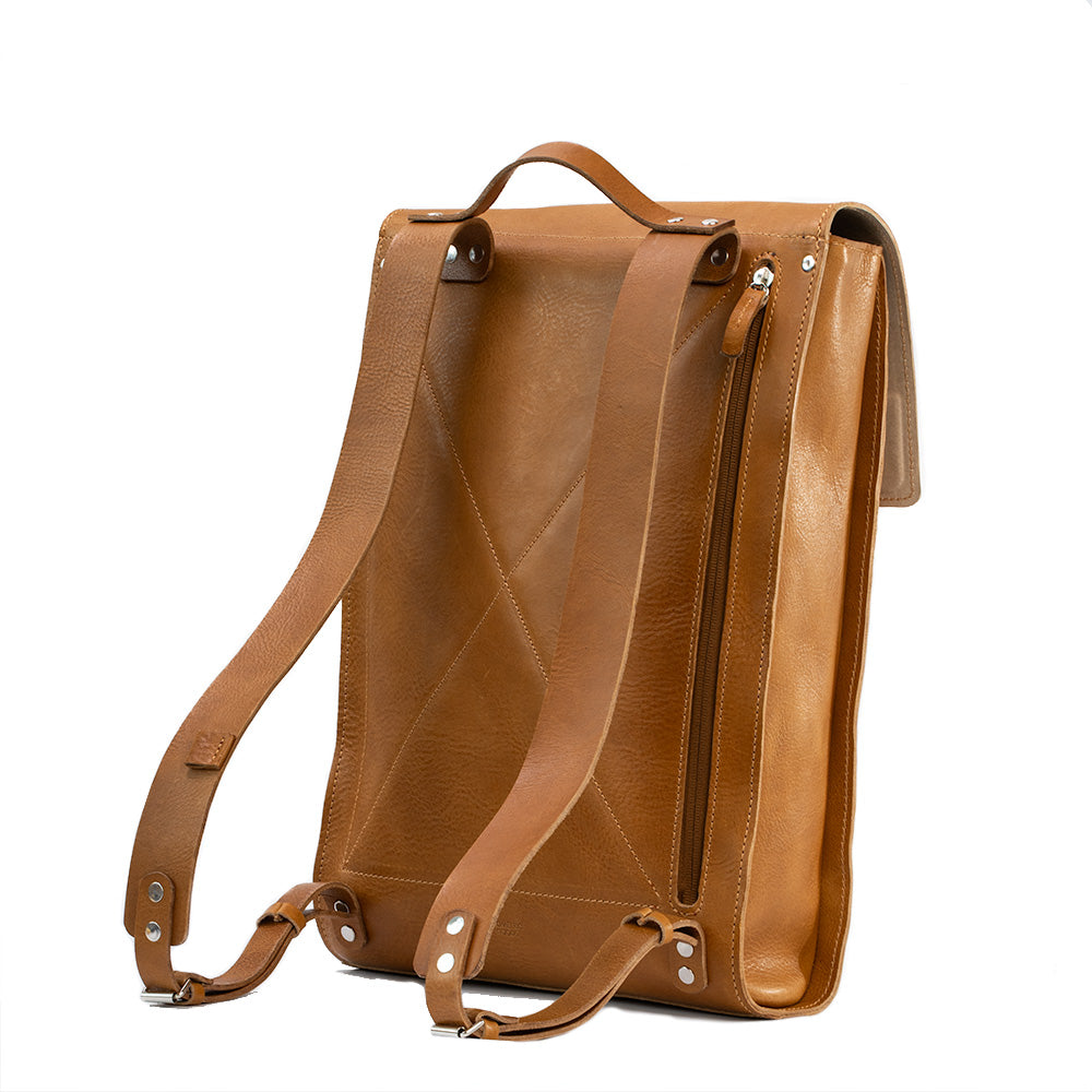 Tan leather laptop backpack with adjustable straps and multiple pockets, showcasing its minimalist design and eco-friendly materials.