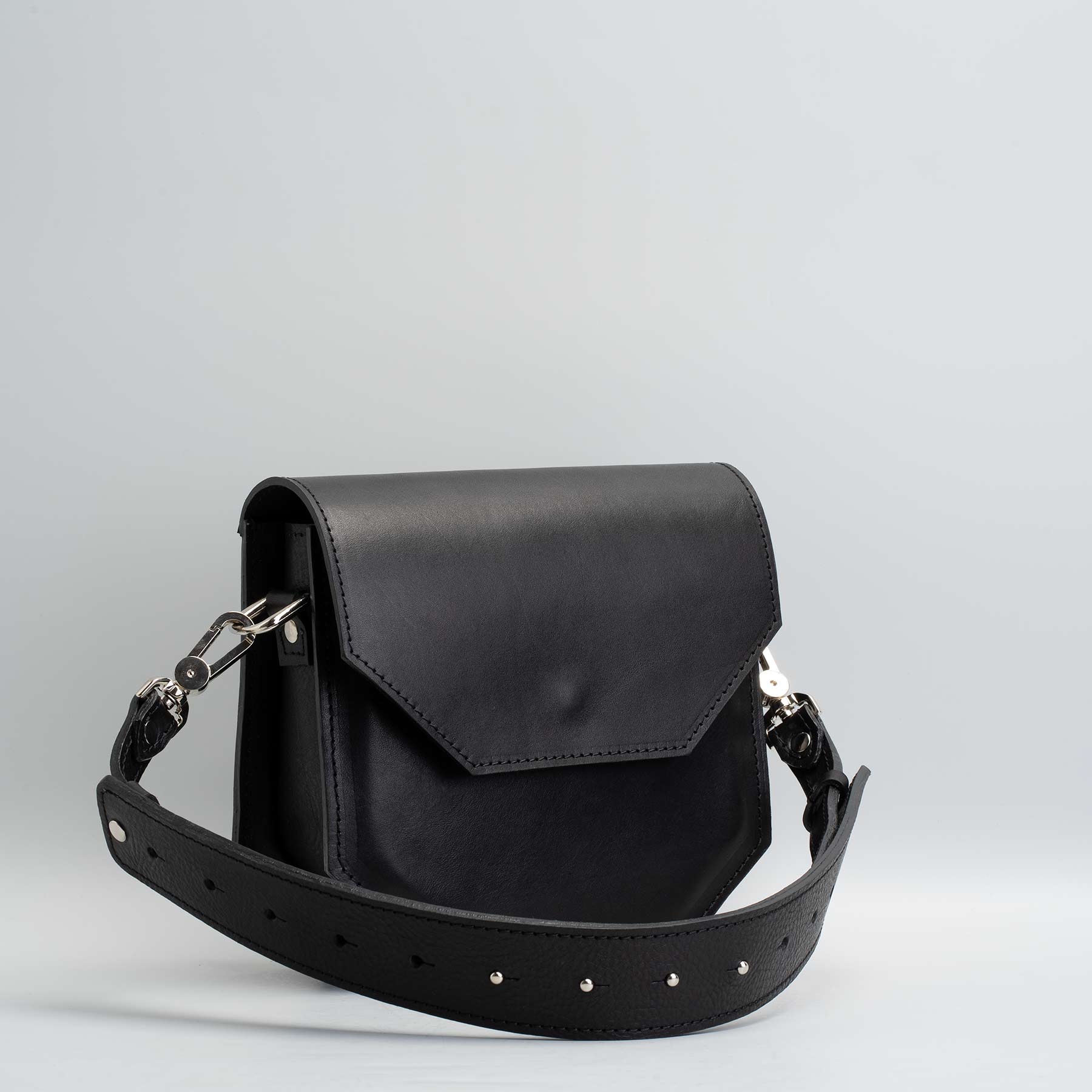 Hypatia leather purse made of soft black Italian vegetable-tanned leather, featuring a unique hexagon shape and silver hardware.