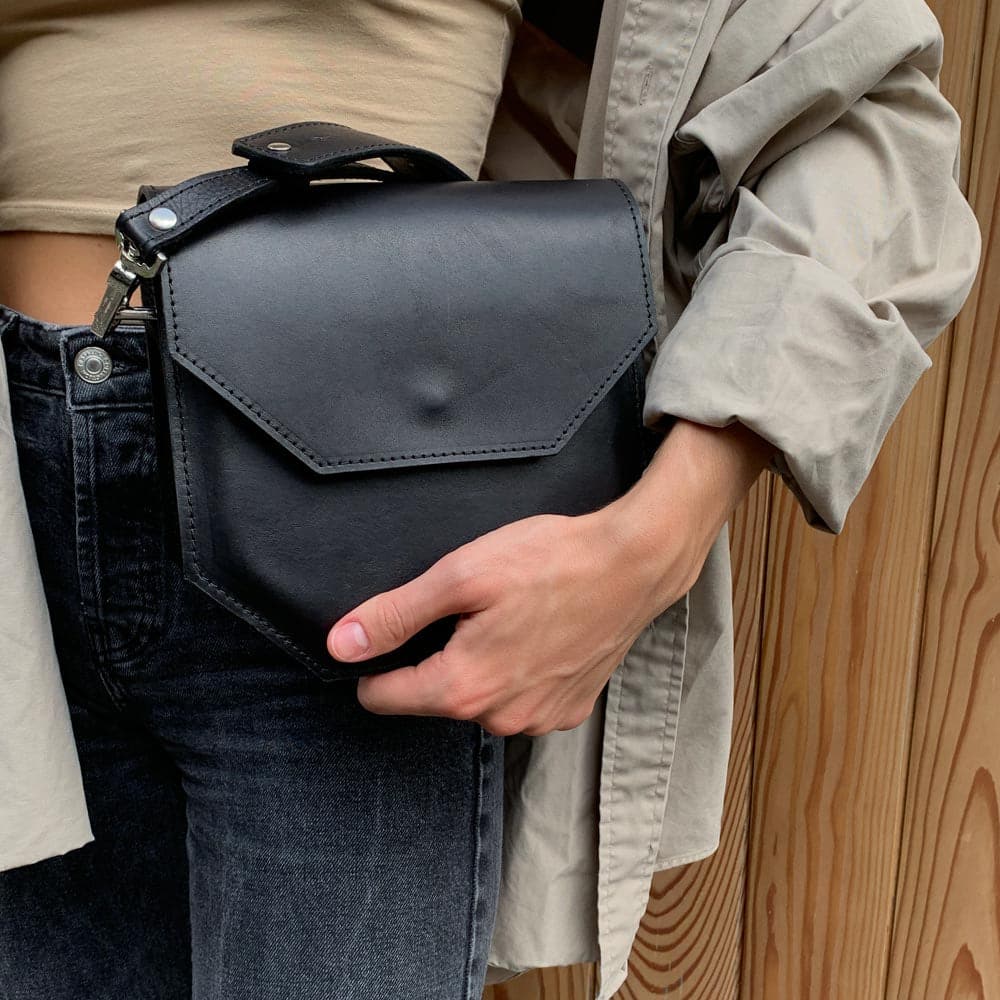 Hypatia leather purse made of soft black Italian vegetable-tanned leather, featuring a unique hexagon shape and silver hardware.