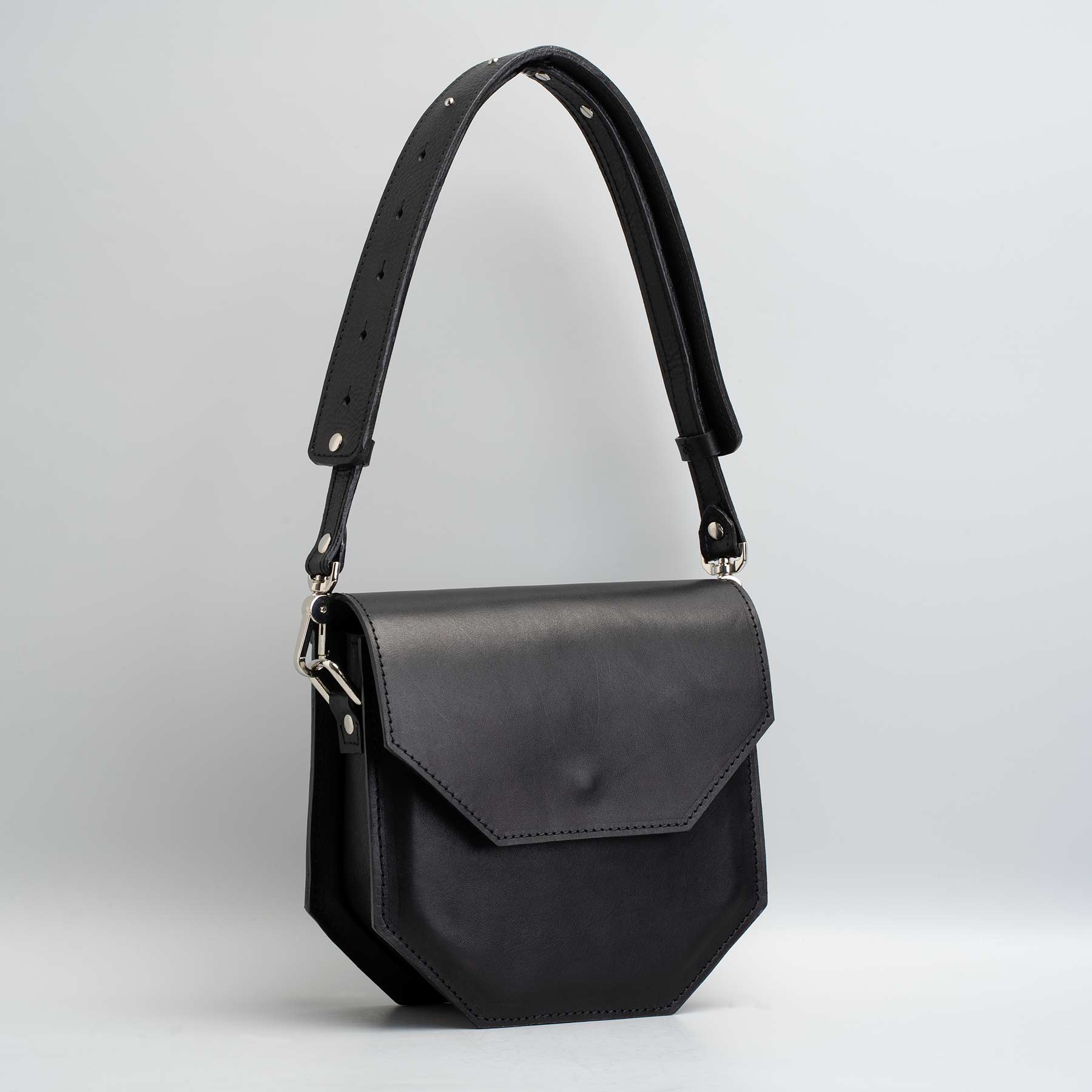 Hypatia leather purse made of soft black Italian vegetable-tanned leather, featuring a unique hexagon shape and silver hardware.