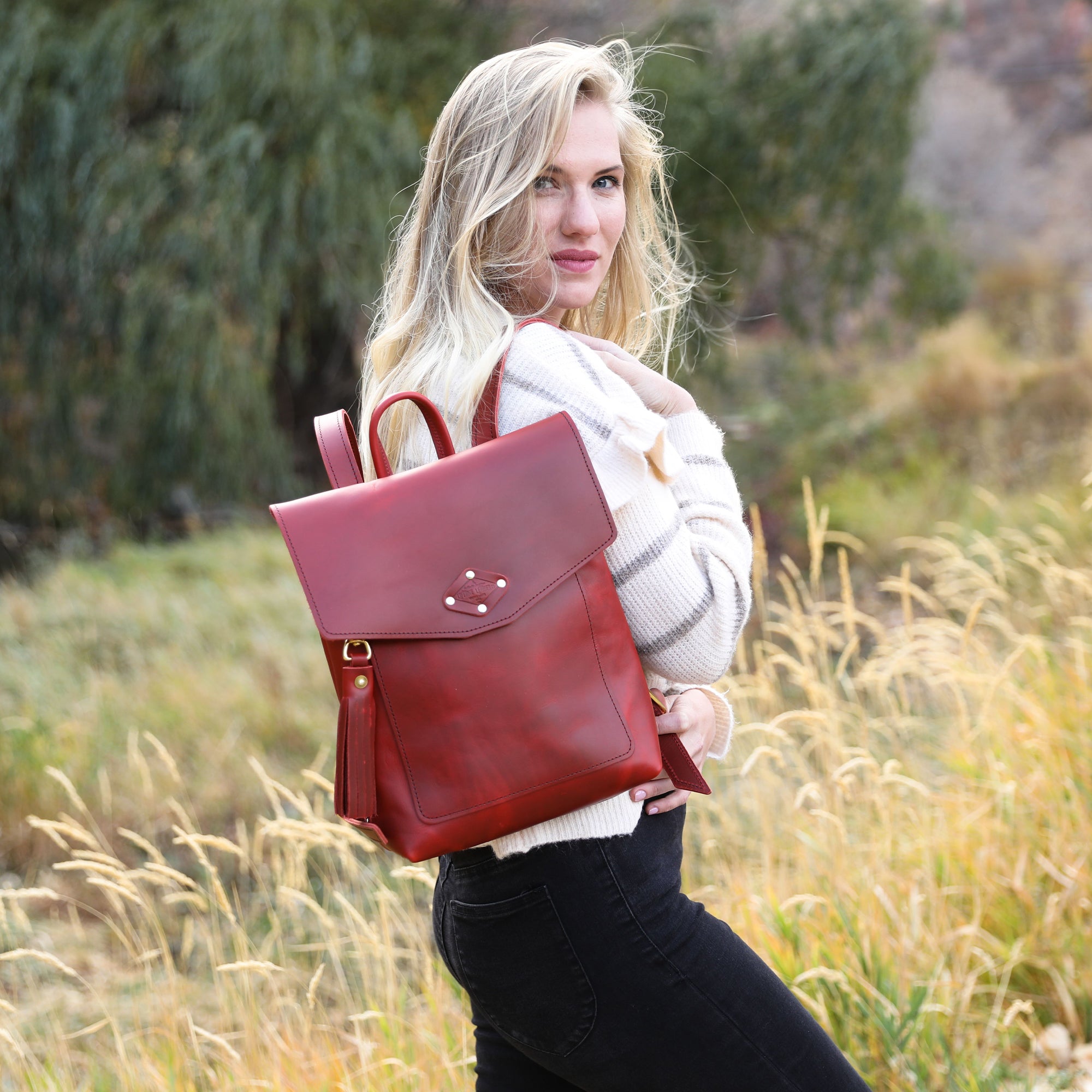 Stylish Leather Rucksack made from full grain leather with adjustable straps and exterior pocket.