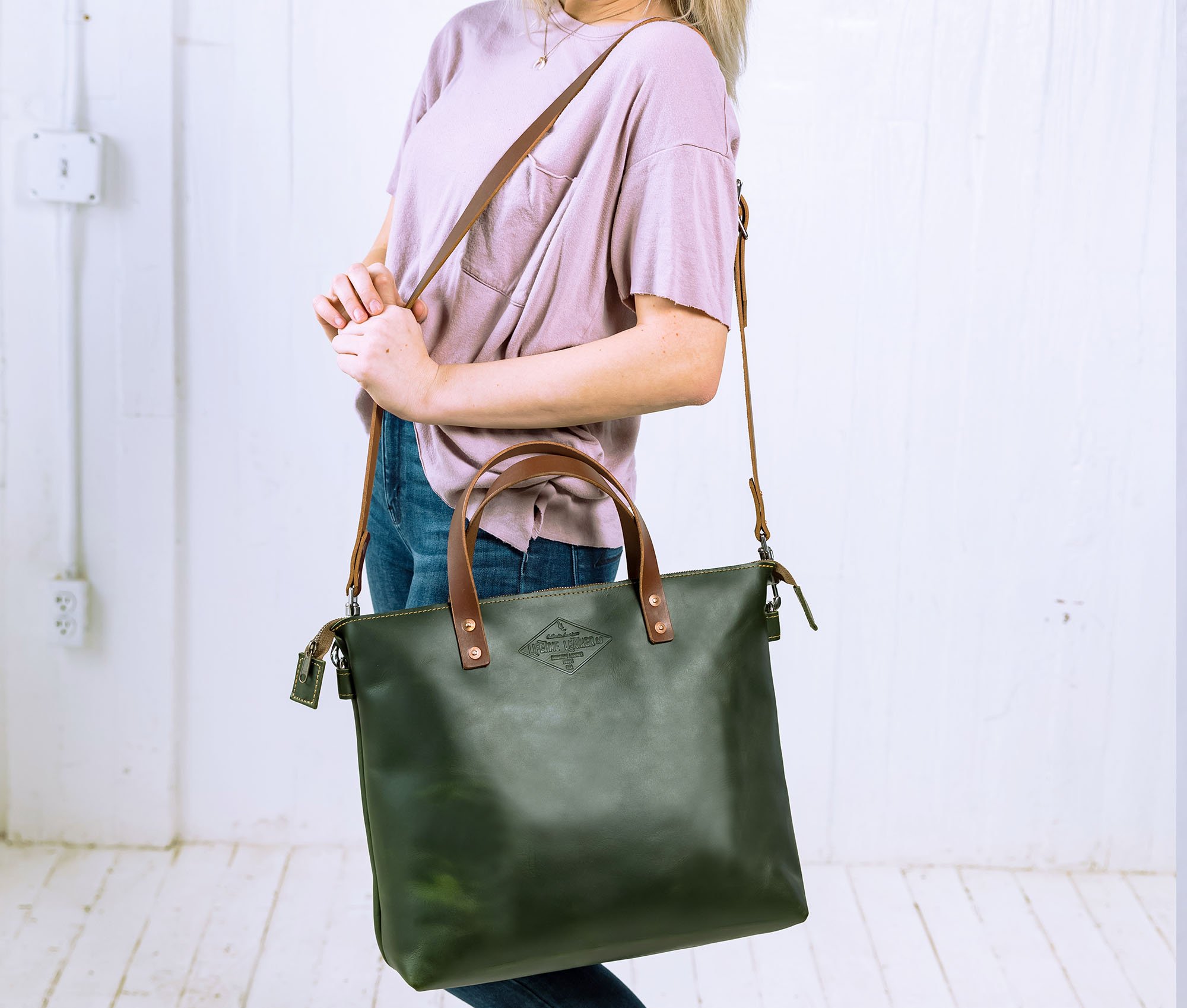 Lifetime Crossbody Tote made of full grain leather, featuring adjustable strap and spacious interior pockets.