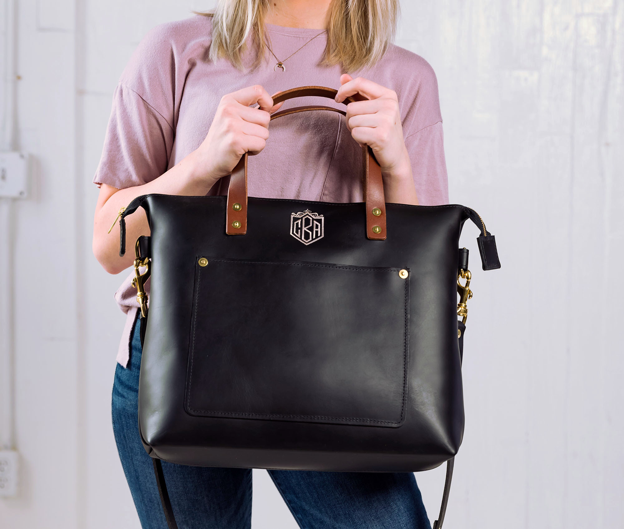 Lifetime Crossbody Tote made of full grain leather, featuring adjustable strap and spacious interior pockets.