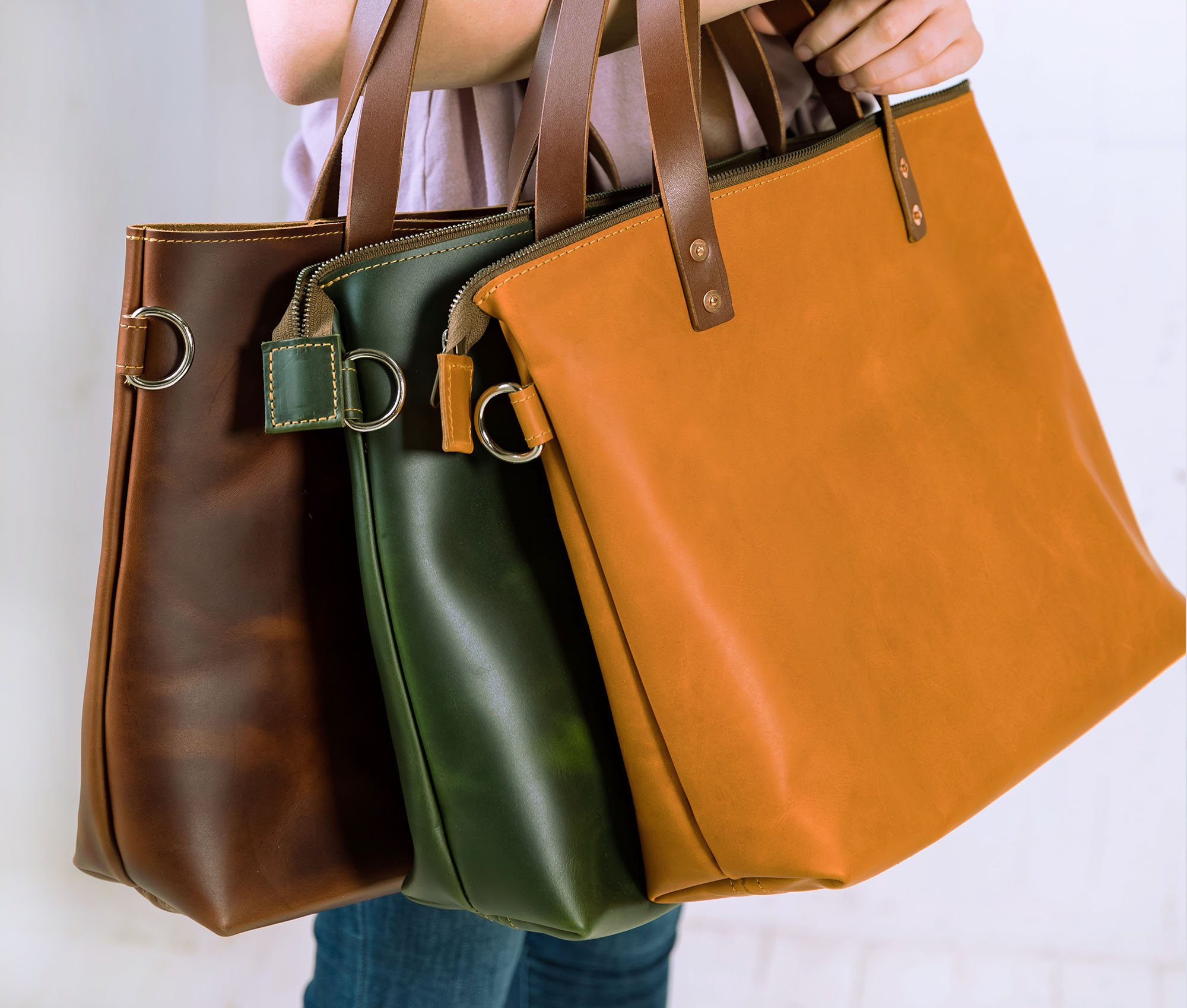 Lifetime Crossbody Tote made of full grain leather, featuring adjustable strap and spacious interior pockets.