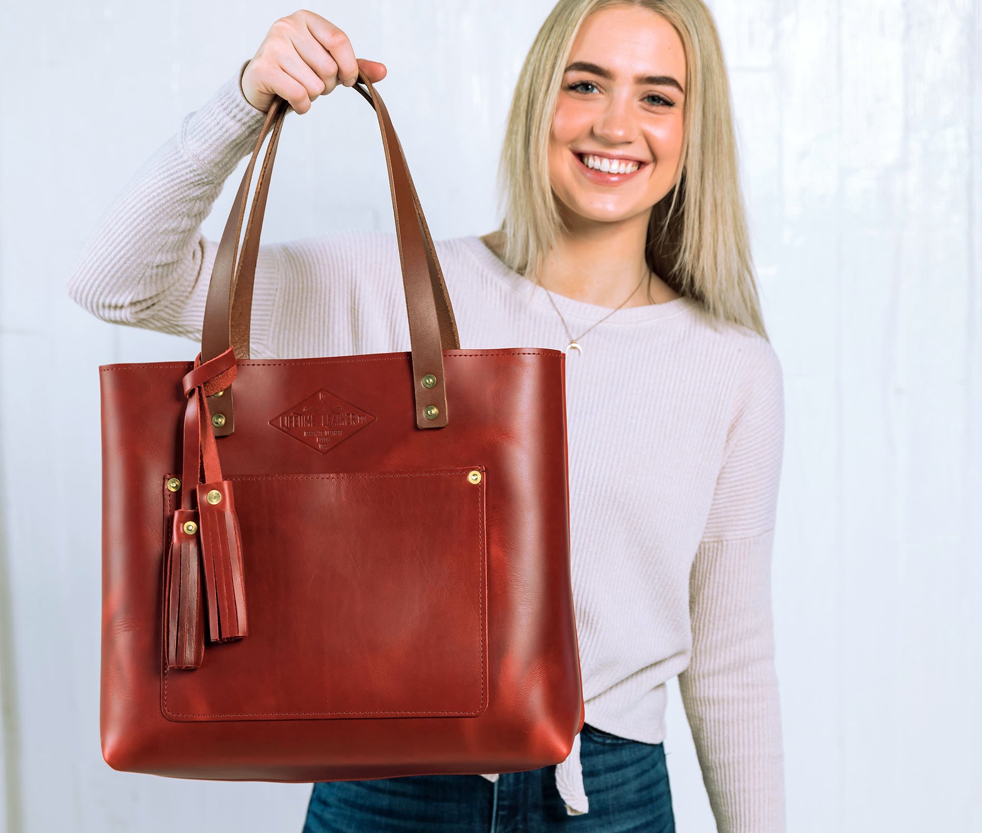 A stylish Lifetime Tote bag made from full grain leather, showcasing its minimalist design and spacious interior.