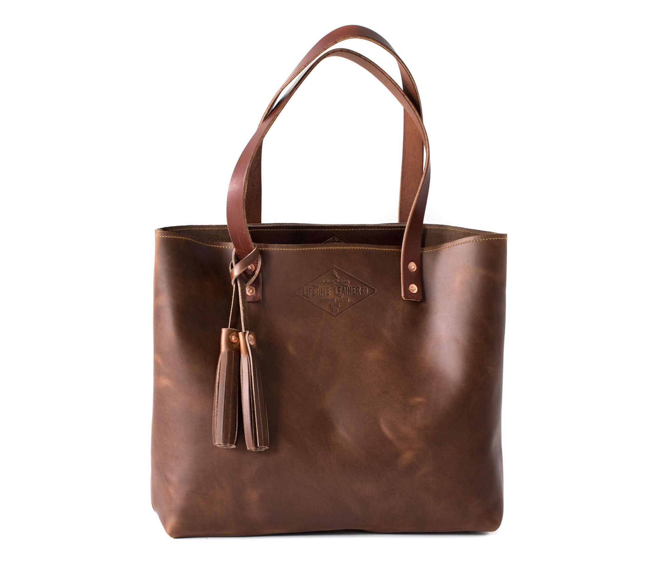 A stylish Lifetime Tote bag made from full grain leather, showcasing its minimalist design and spacious interior.