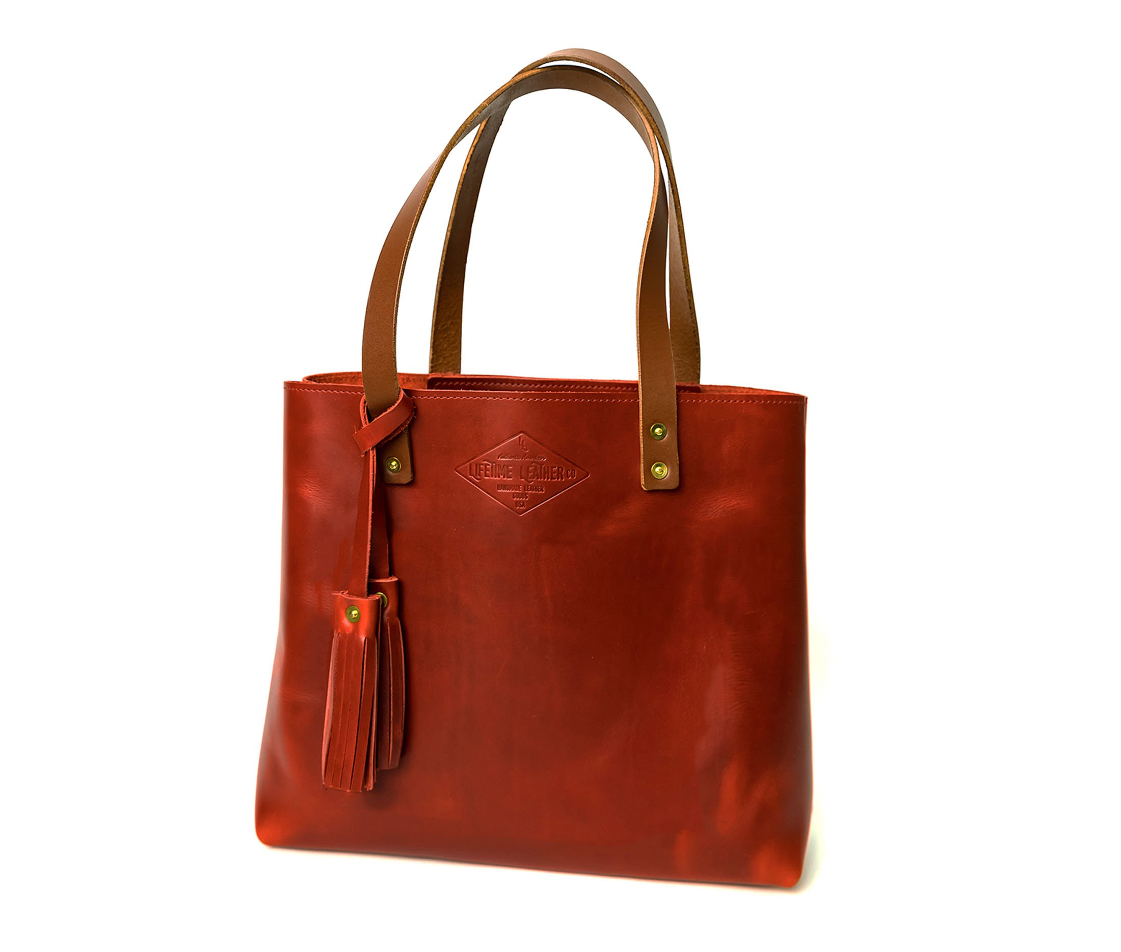 A stylish Lifetime Tote bag made from full grain leather, showcasing its minimalist design and spacious interior.