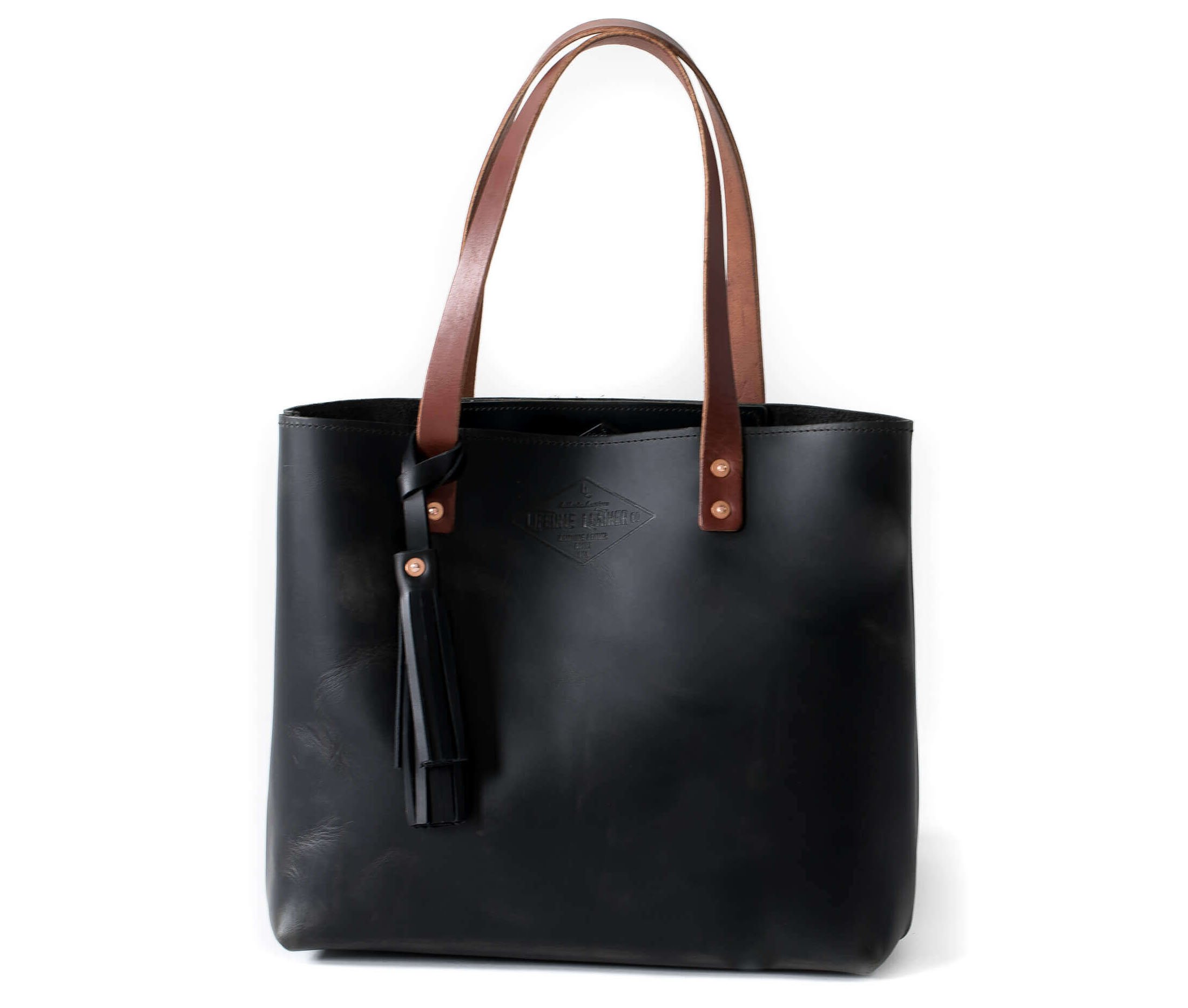 A stylish Lifetime Tote bag made from full grain leather, showcasing its minimalist design and spacious interior.