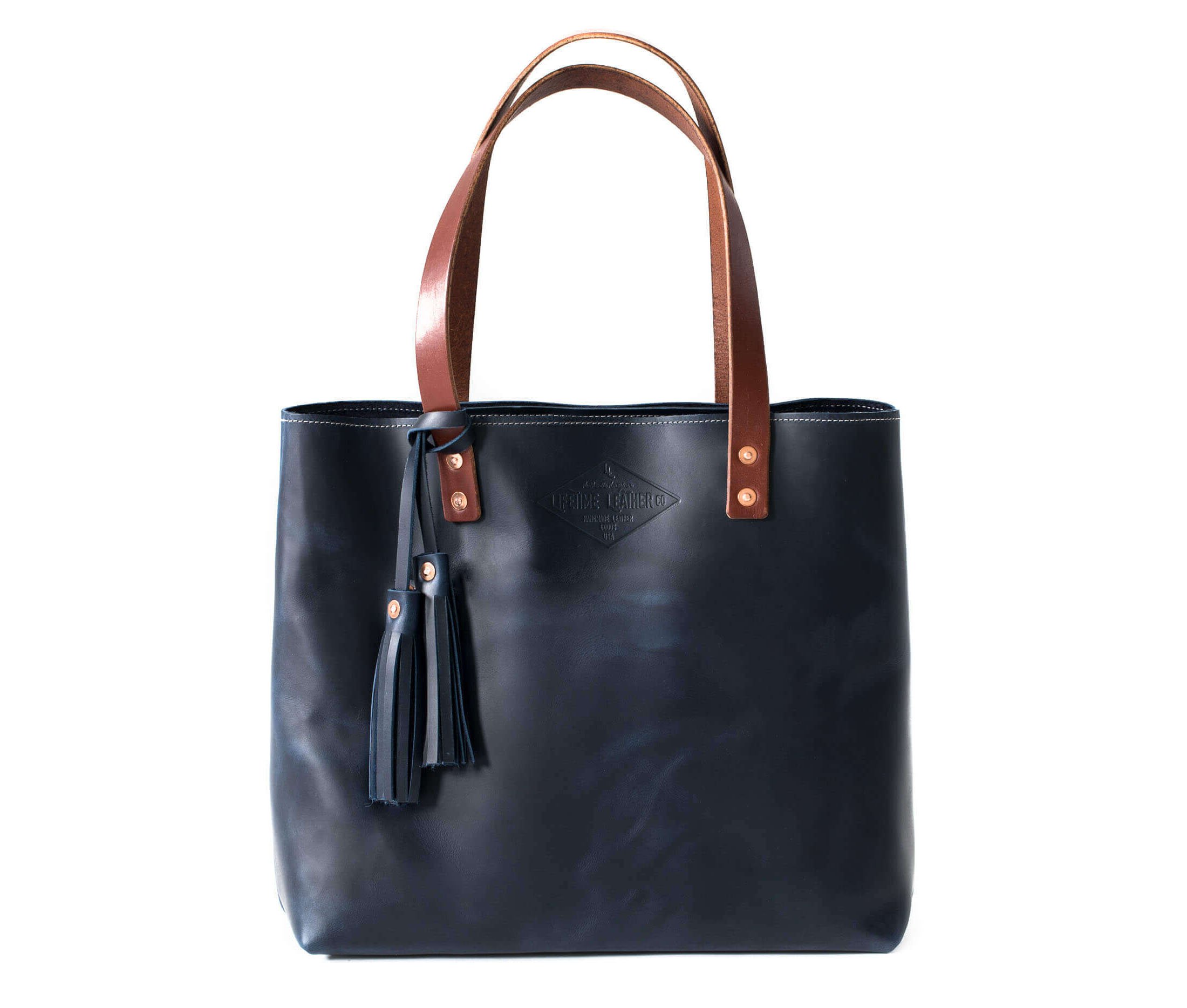 A stylish Lifetime Tote bag made from full grain leather, showcasing its minimalist design and spacious interior.