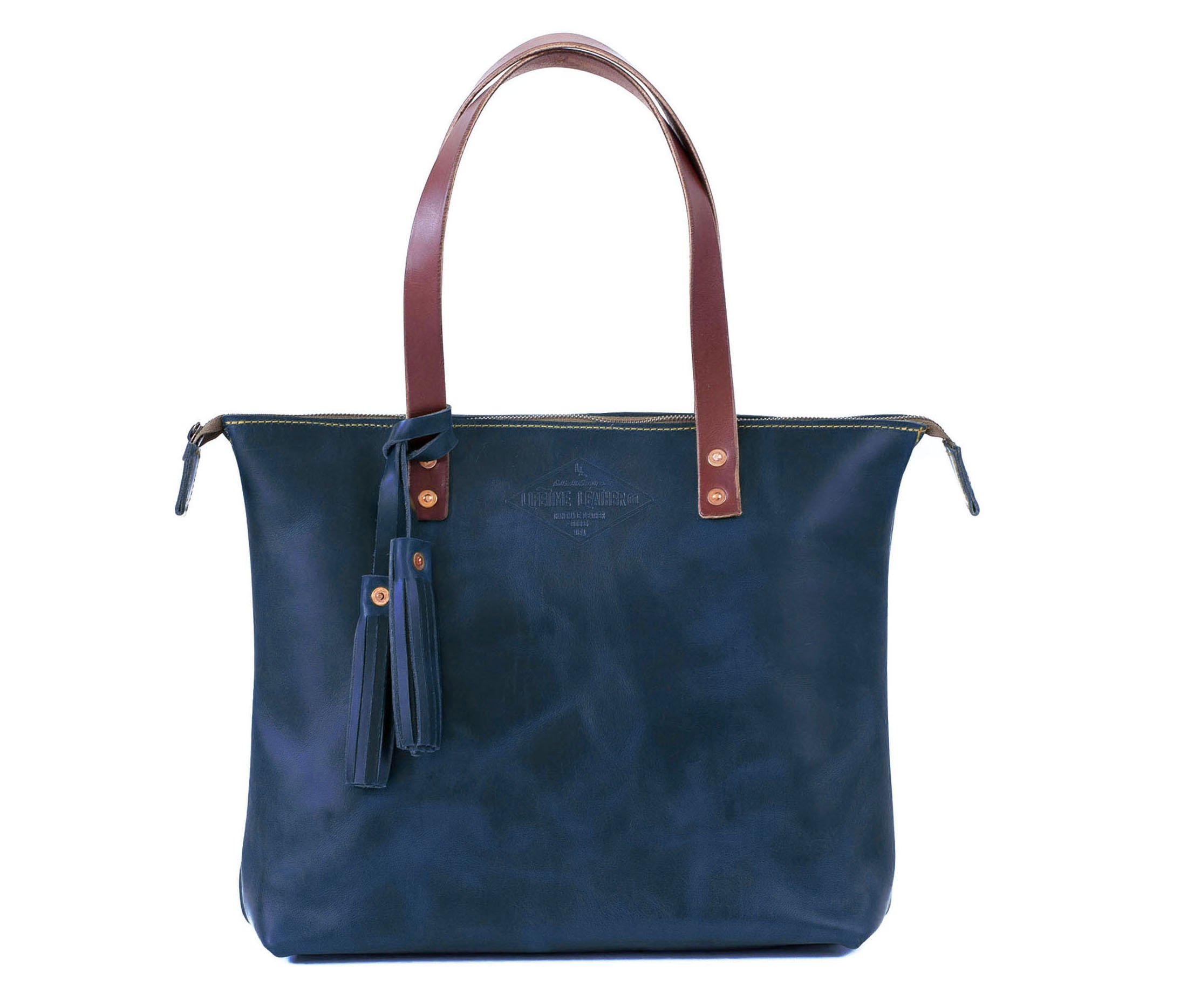 Lifetime Zippered Tote made of genuine American full grain leather, featuring a zippered top and multiple interior pockets.