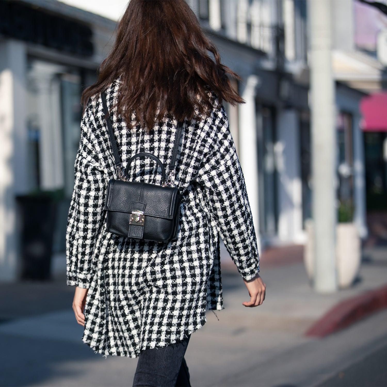 Linda Black Crossbody Backpack Purse made of soft Italian pebble leather with gold hardware, showcasing its stylish design and versatility.