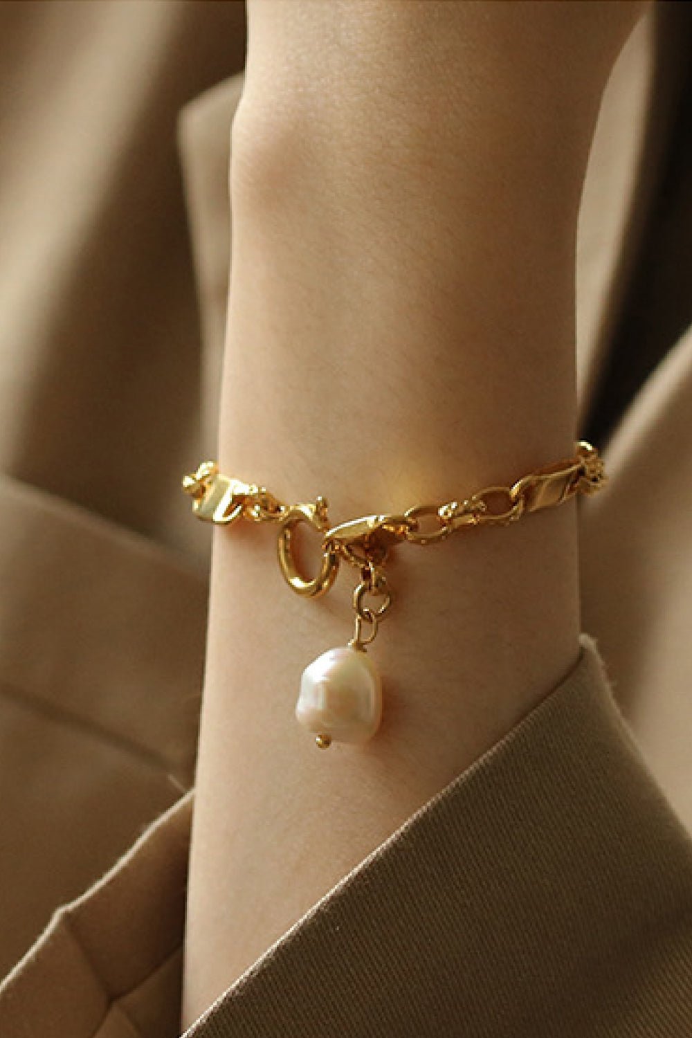 A stylish Link Chain Bracelet featuring a chunky gold plated brass chain and a delicate pearl pendant, perfect for elegant accessorizing.