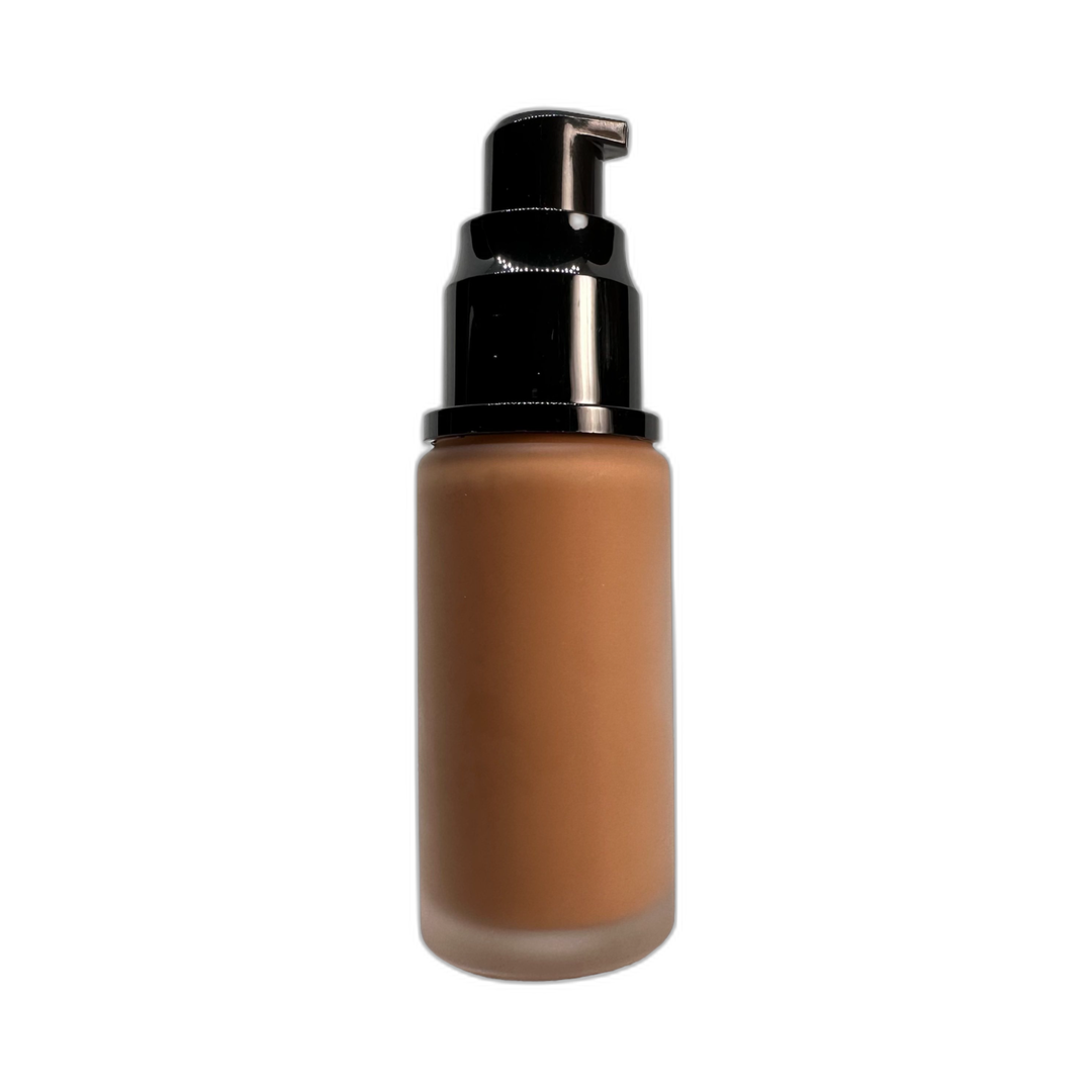 A bottle of Tahini Liquid Foundation showcasing its sleek design and rich color, perfect for achieving a flawless complexion.