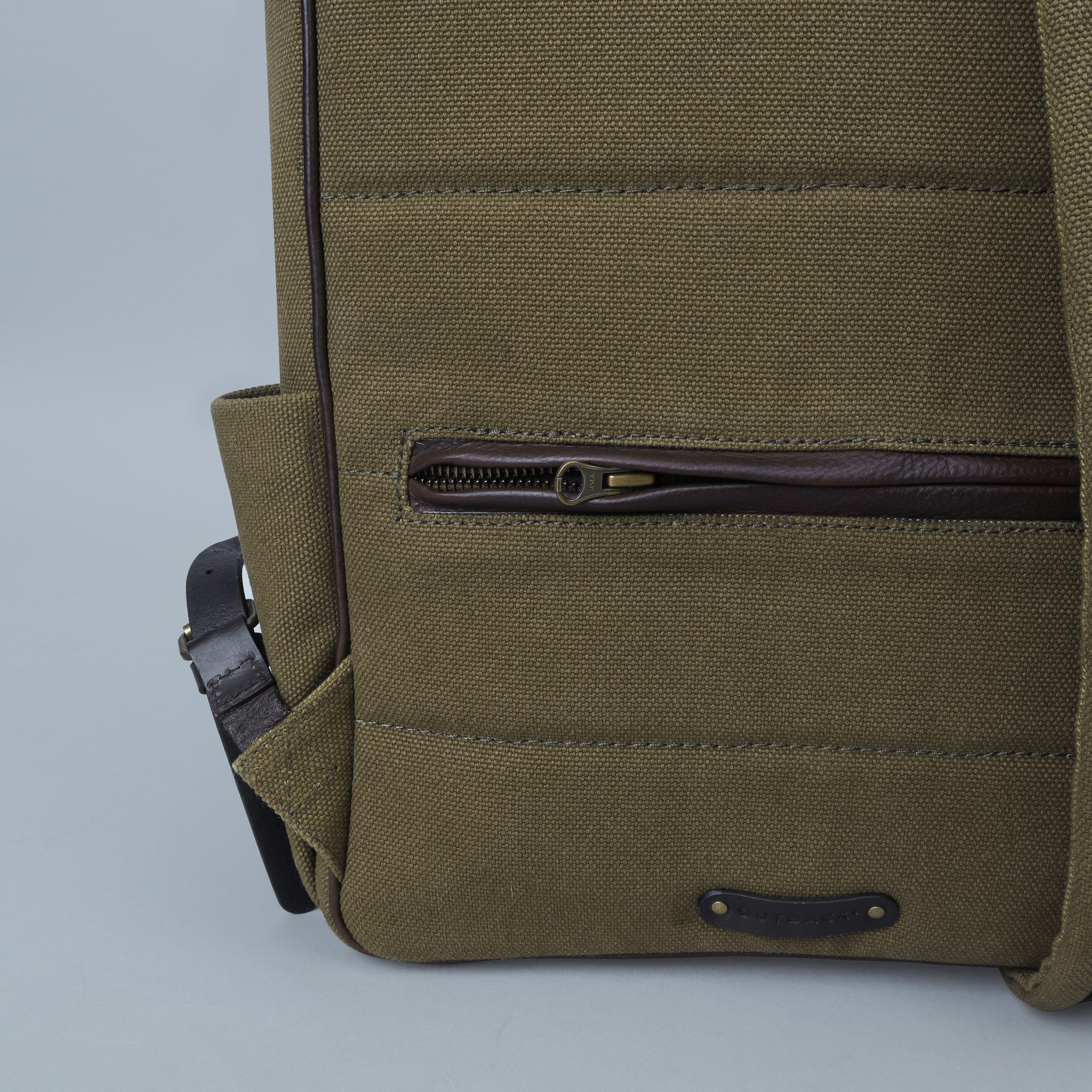 London Canvas Backpack featuring durable cotton canvas, adjustable straps, and multiple pockets for organization.