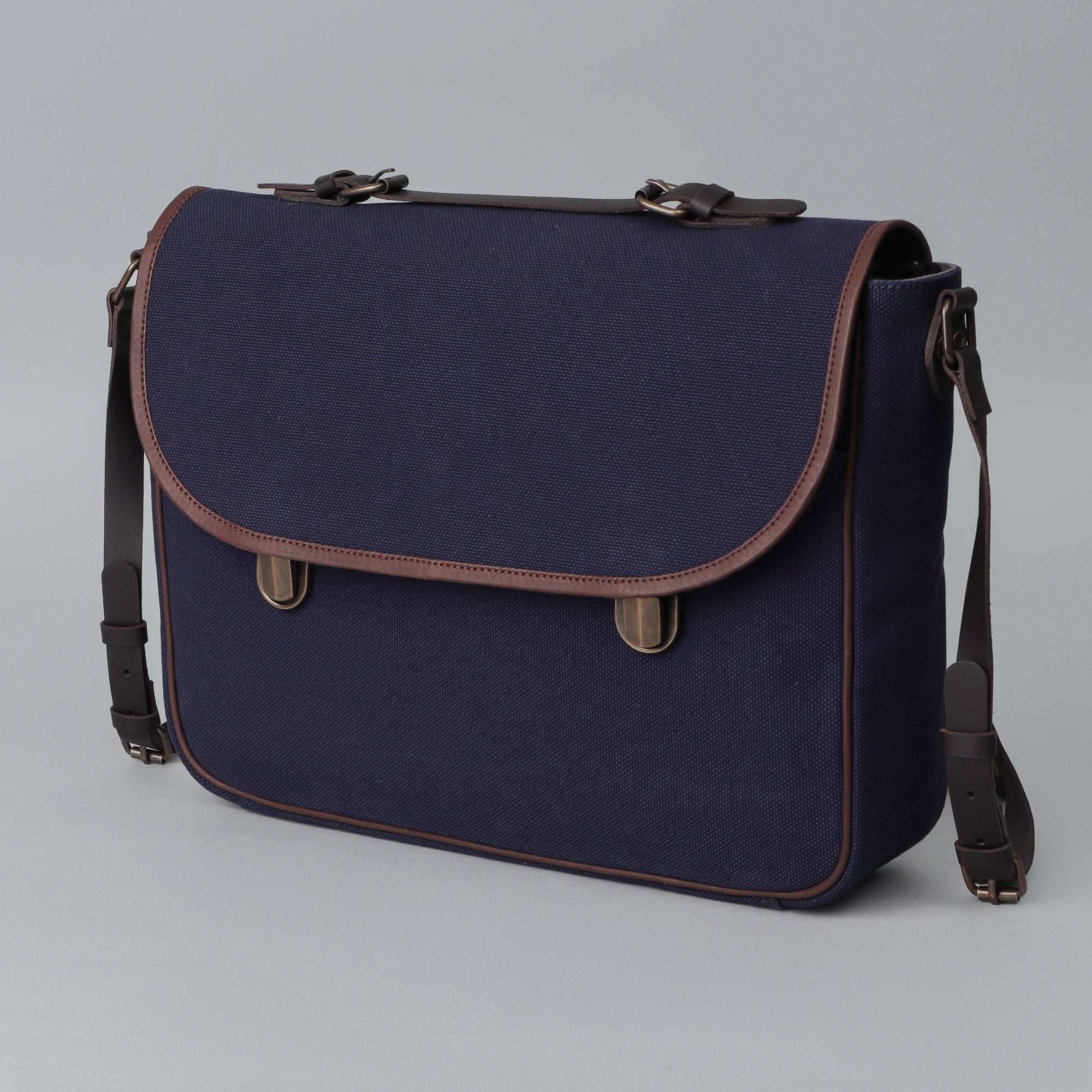 London Canvas Briefcase featuring a separate laptop section, zipper pocket, and durable materials, ideal for professionals.