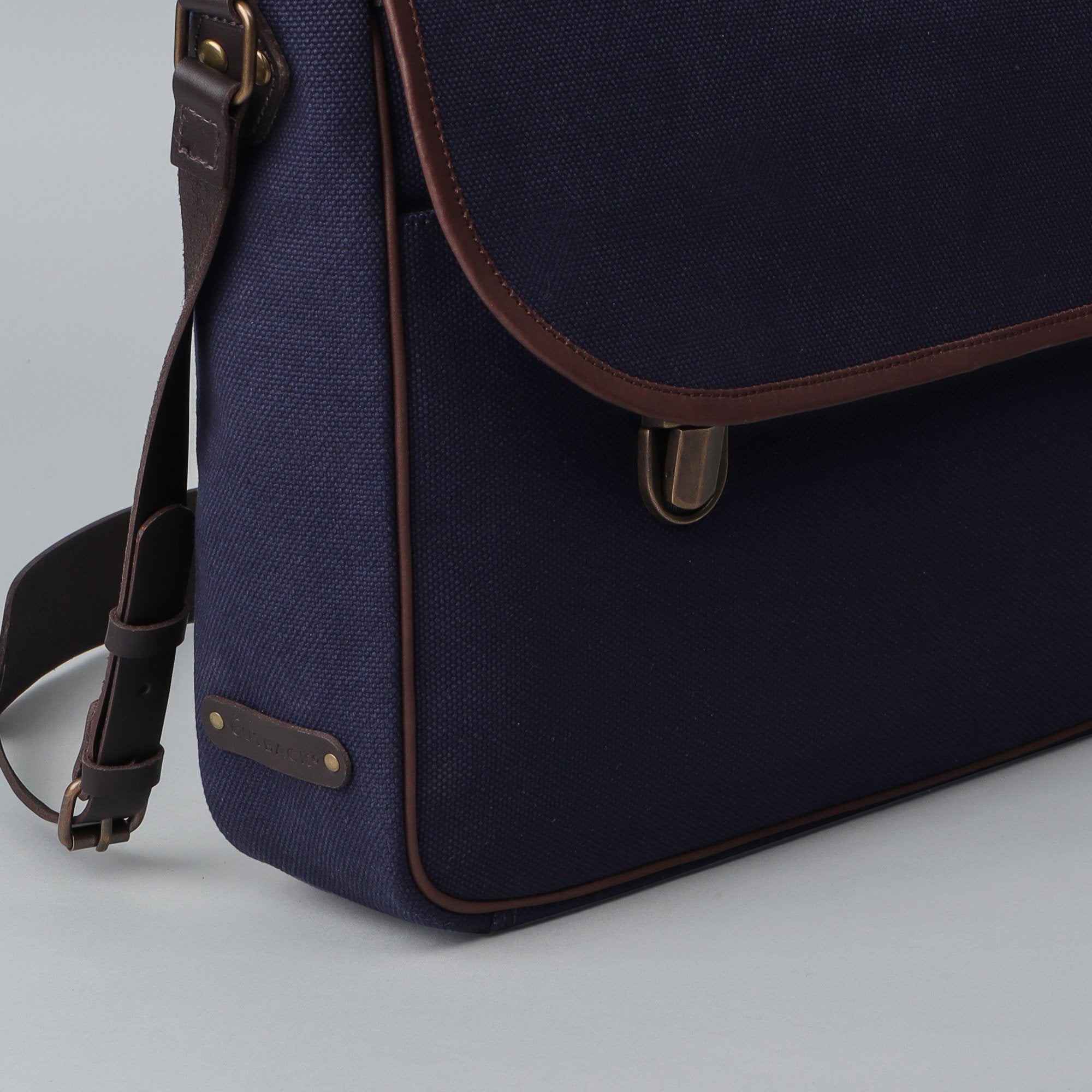 London Canvas Briefcase featuring a separate laptop section, zipper pocket, and durable materials, ideal for professionals.