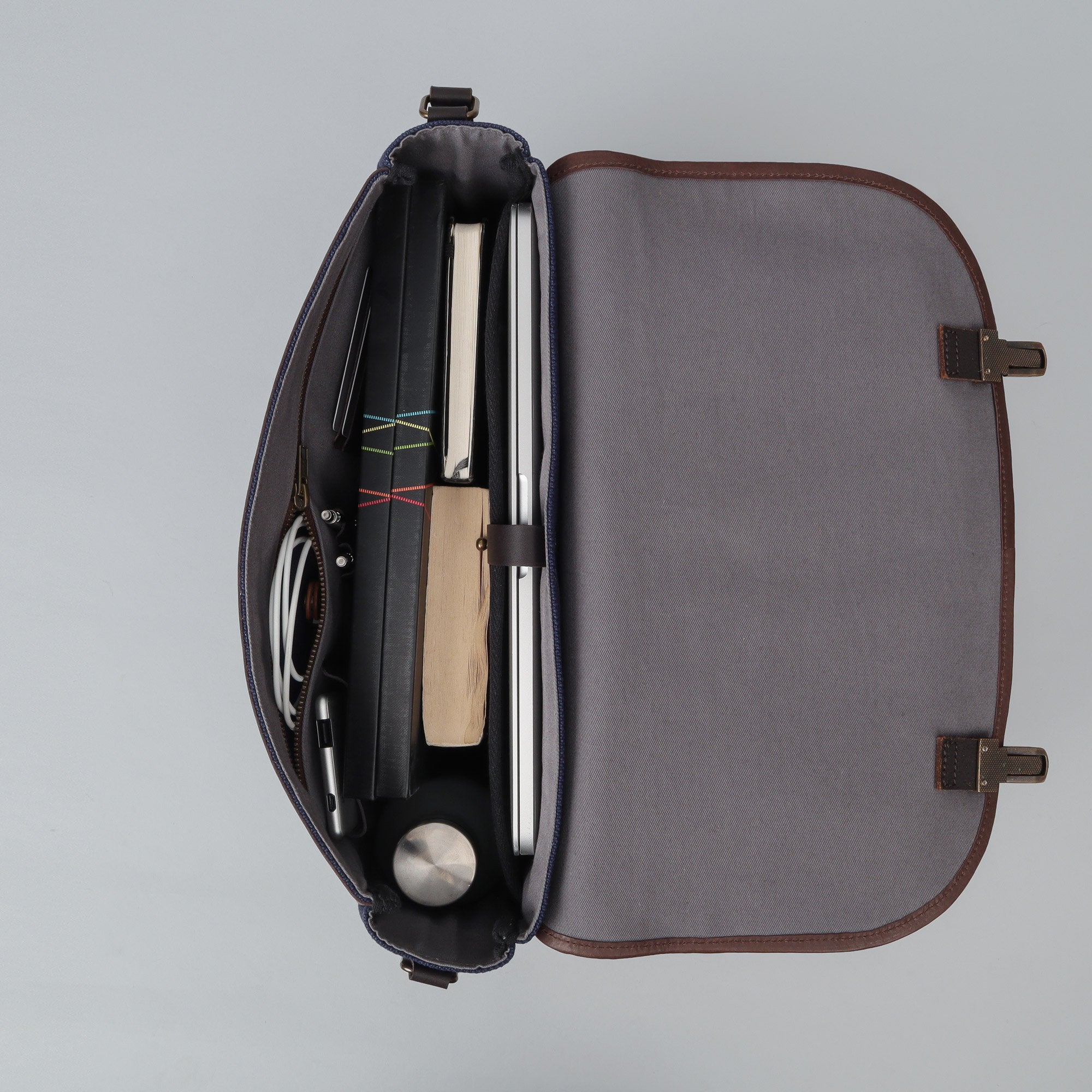 London Canvas Briefcase featuring a separate laptop section, zipper pocket, and durable materials, ideal for professionals.