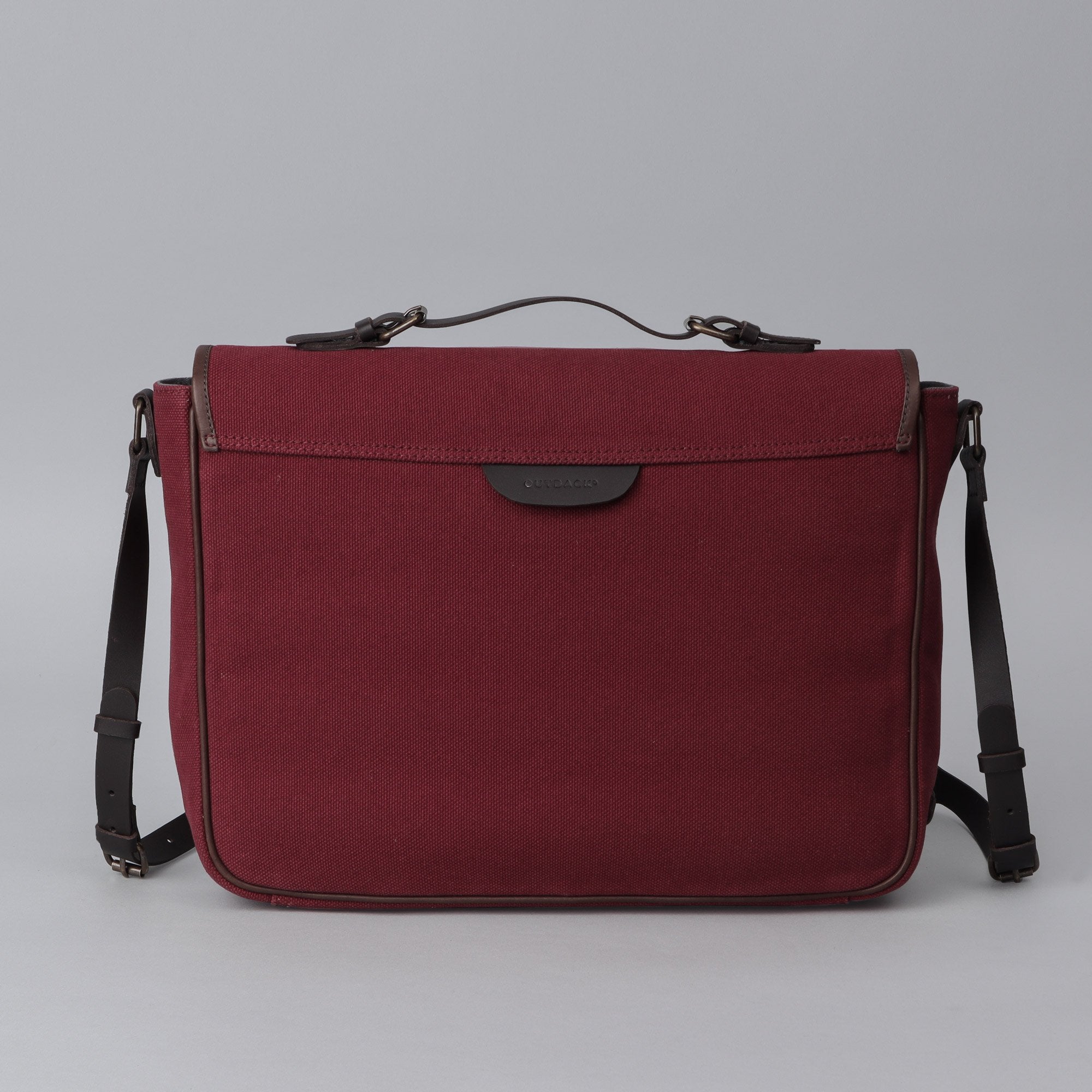 London Canvas Briefcase made from durable cotton canvas with leather straps, featuring a laptop compartment and multiple pockets.