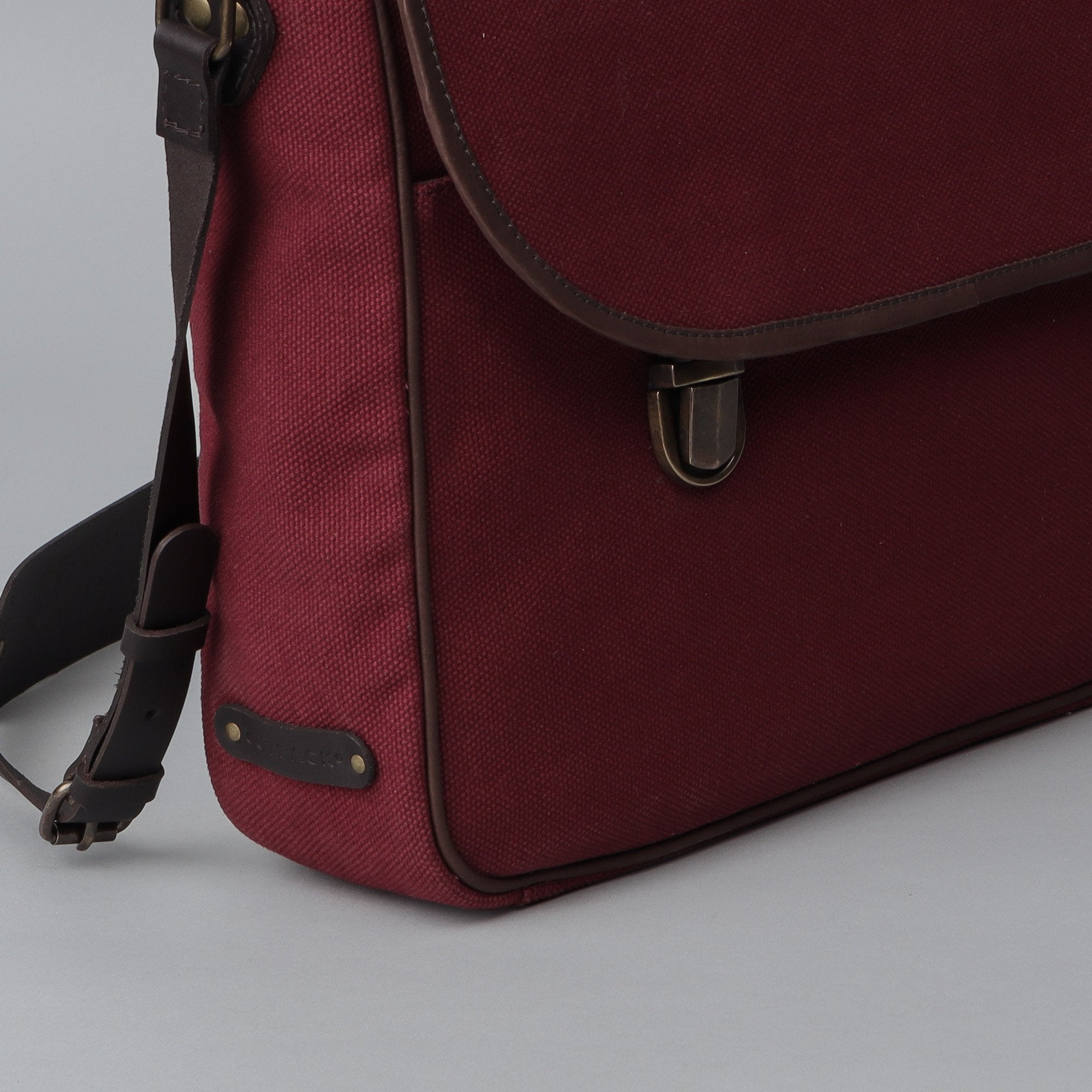 London Canvas Briefcase made from durable cotton canvas with leather straps, featuring a laptop compartment and multiple pockets.