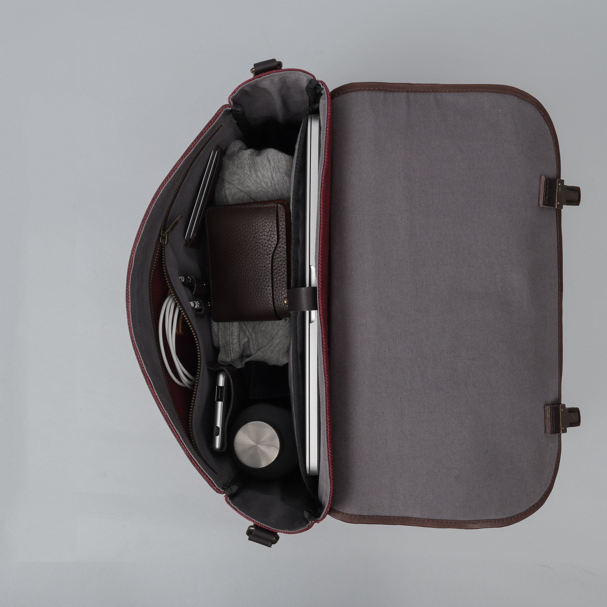 London Canvas Briefcase made from durable cotton canvas with leather straps, featuring a laptop compartment and multiple pockets.